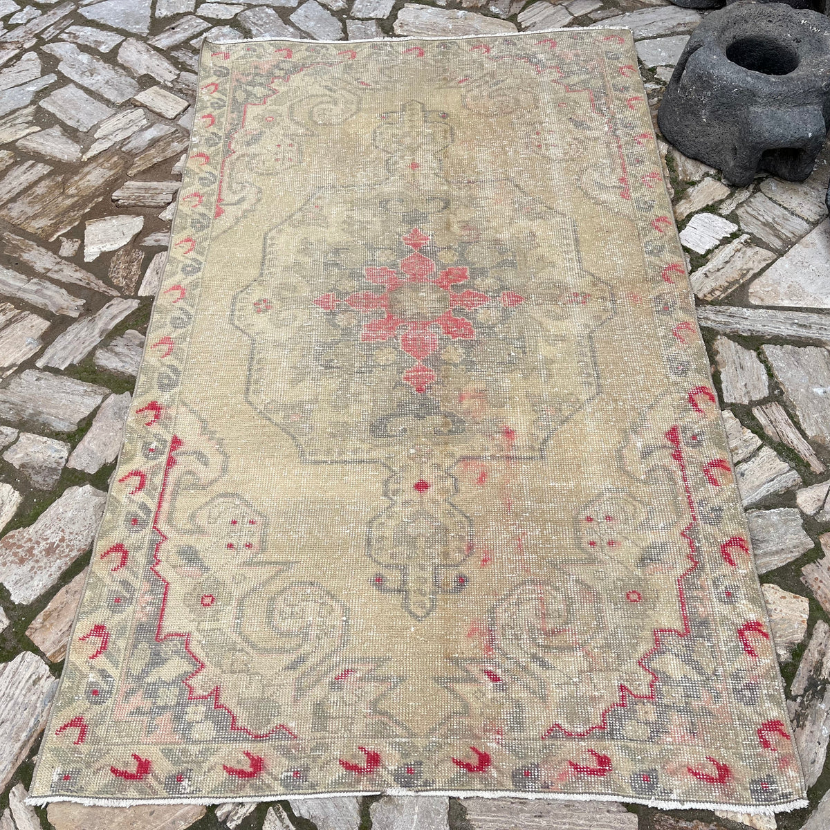 Beige 4' x 7' vintage Turkish distressed rug in wool and cotton, shown on the floor.
