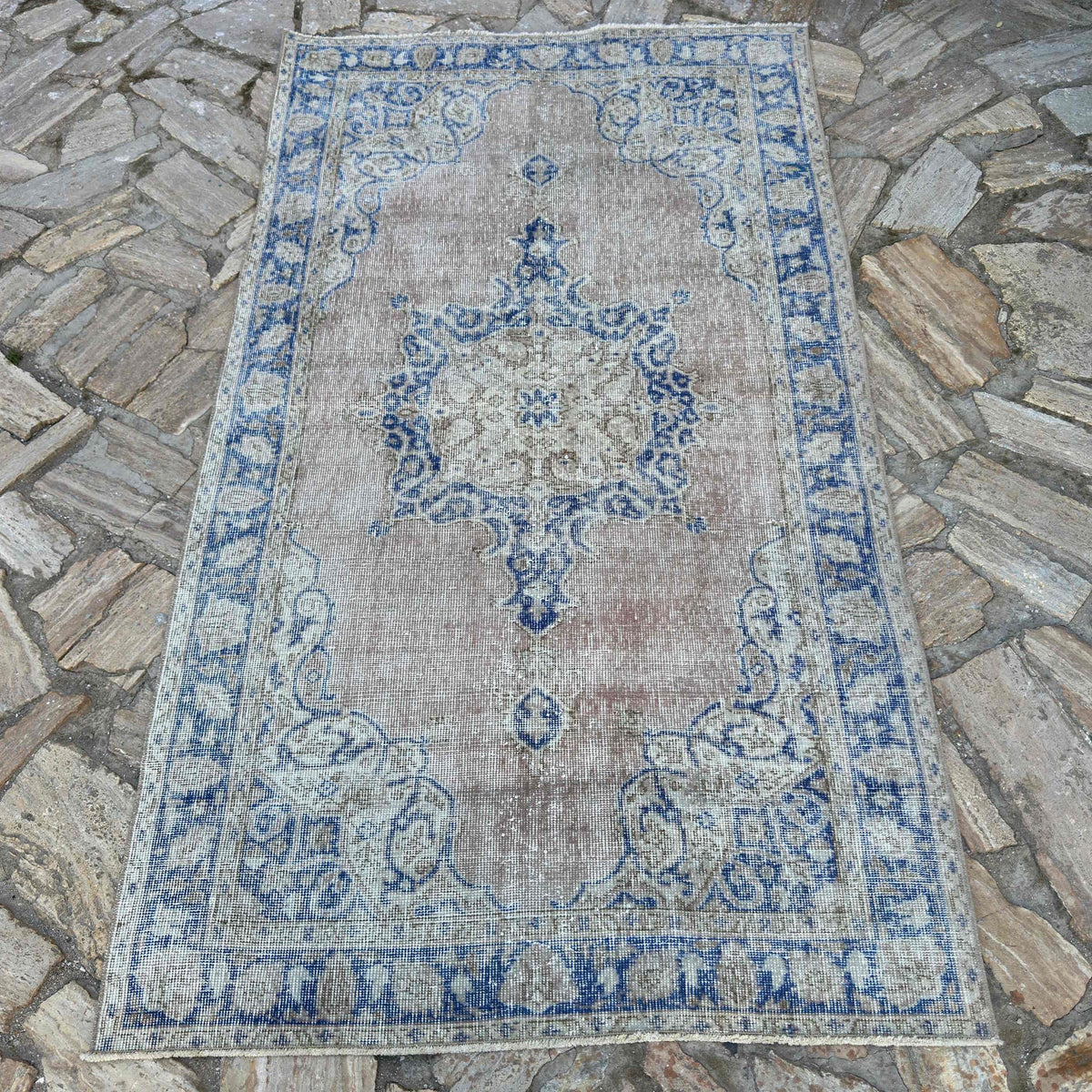 Blue 4' x 7' vintage Turkish distressed rug in wool and cotton, shown on the floor.