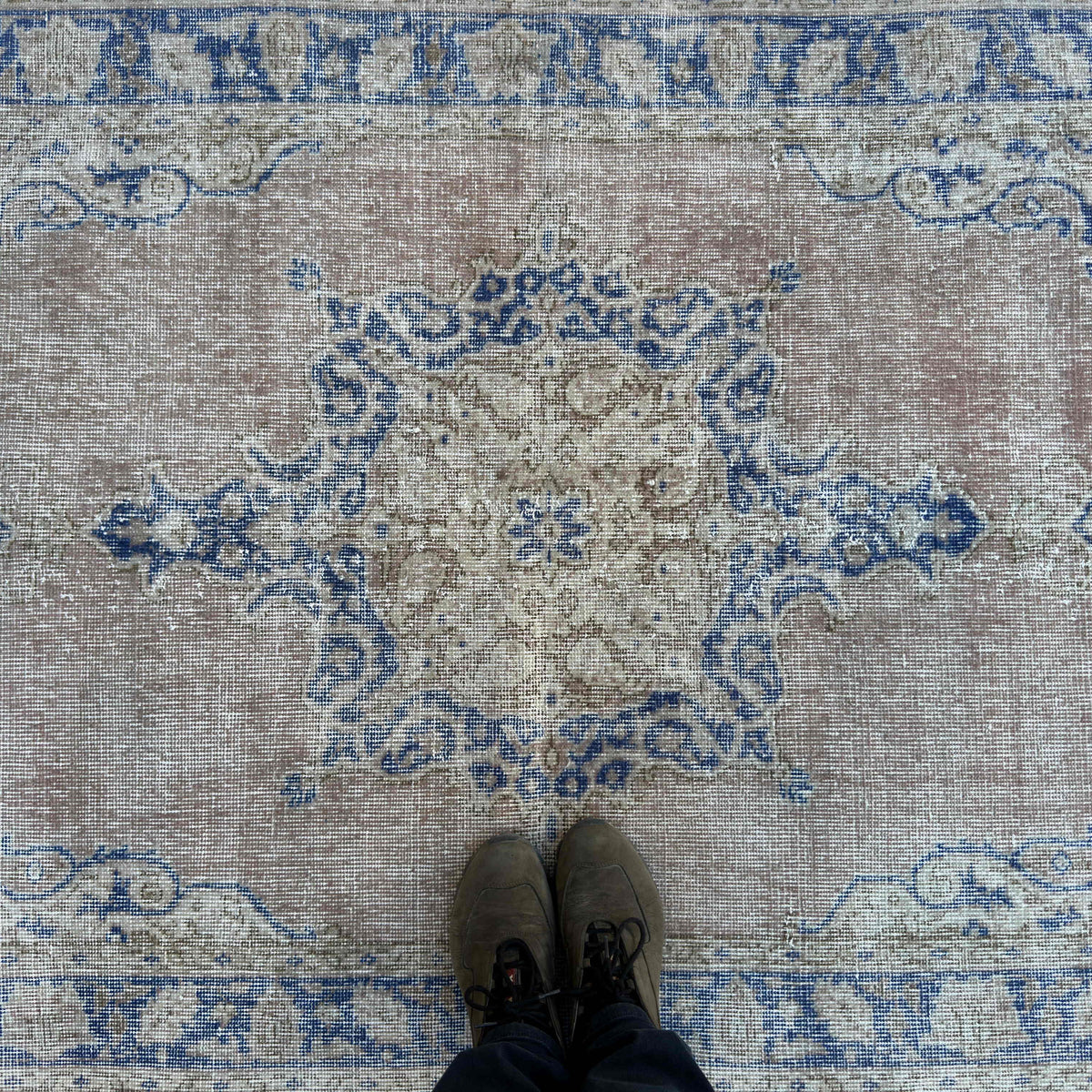 1970s blue vintage Turkish distressed rug with geometric design, hand-knotted weave and low pile.