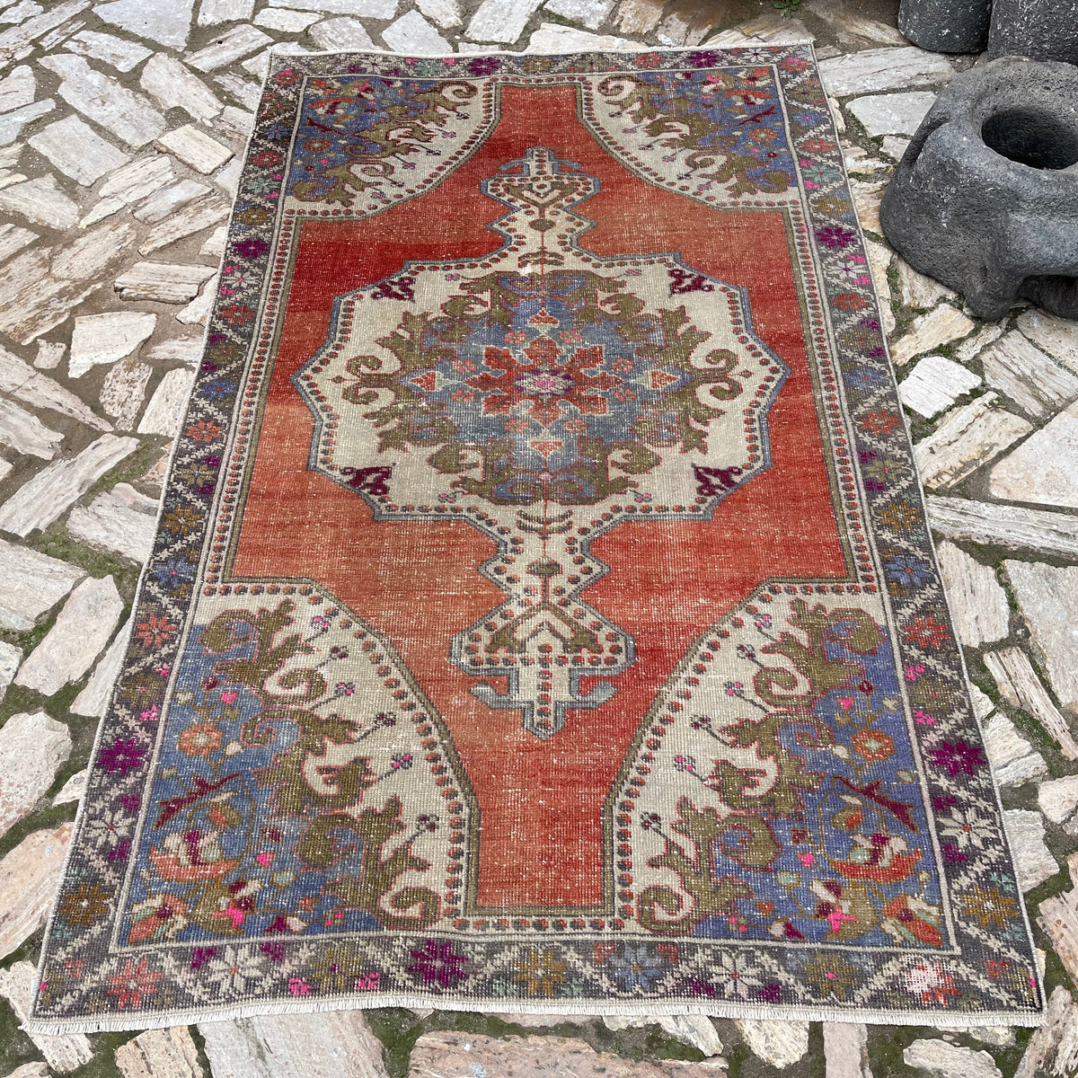 Pale Red 4' x 7' vintage Turkish distressed rug in wool and cotton, shown on the floor.