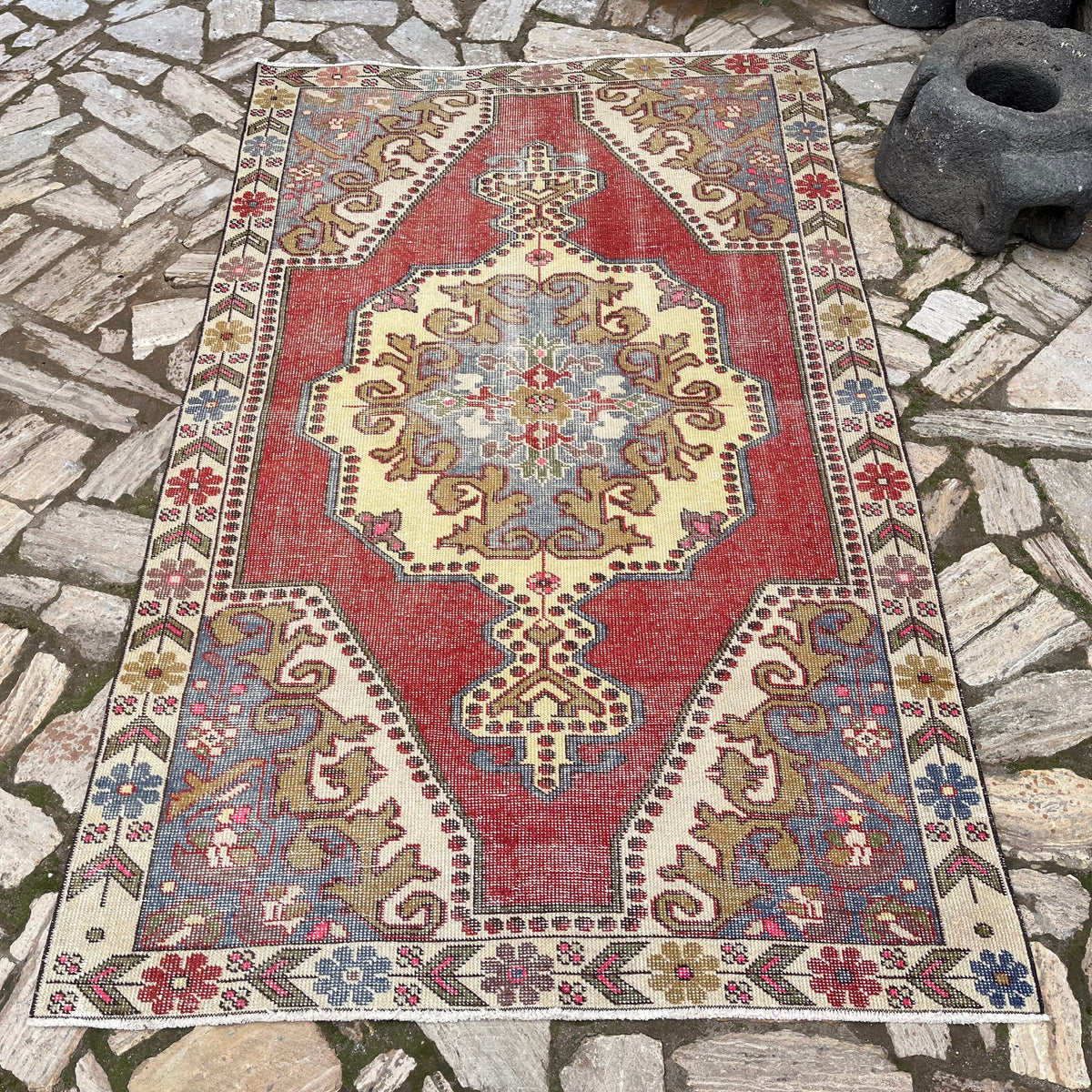 Red 5' x 7' vintage Turkish distressed rug in wool and cotton, shown on the floor.