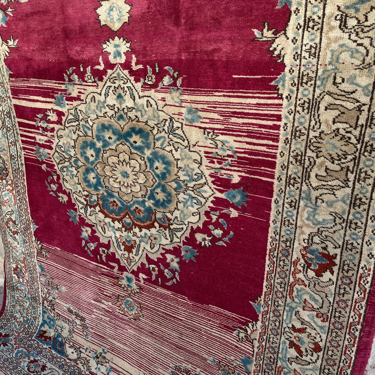 1970s red vintage Turkish distressed rug with medallion design, hand-knotted weave and low pile.
