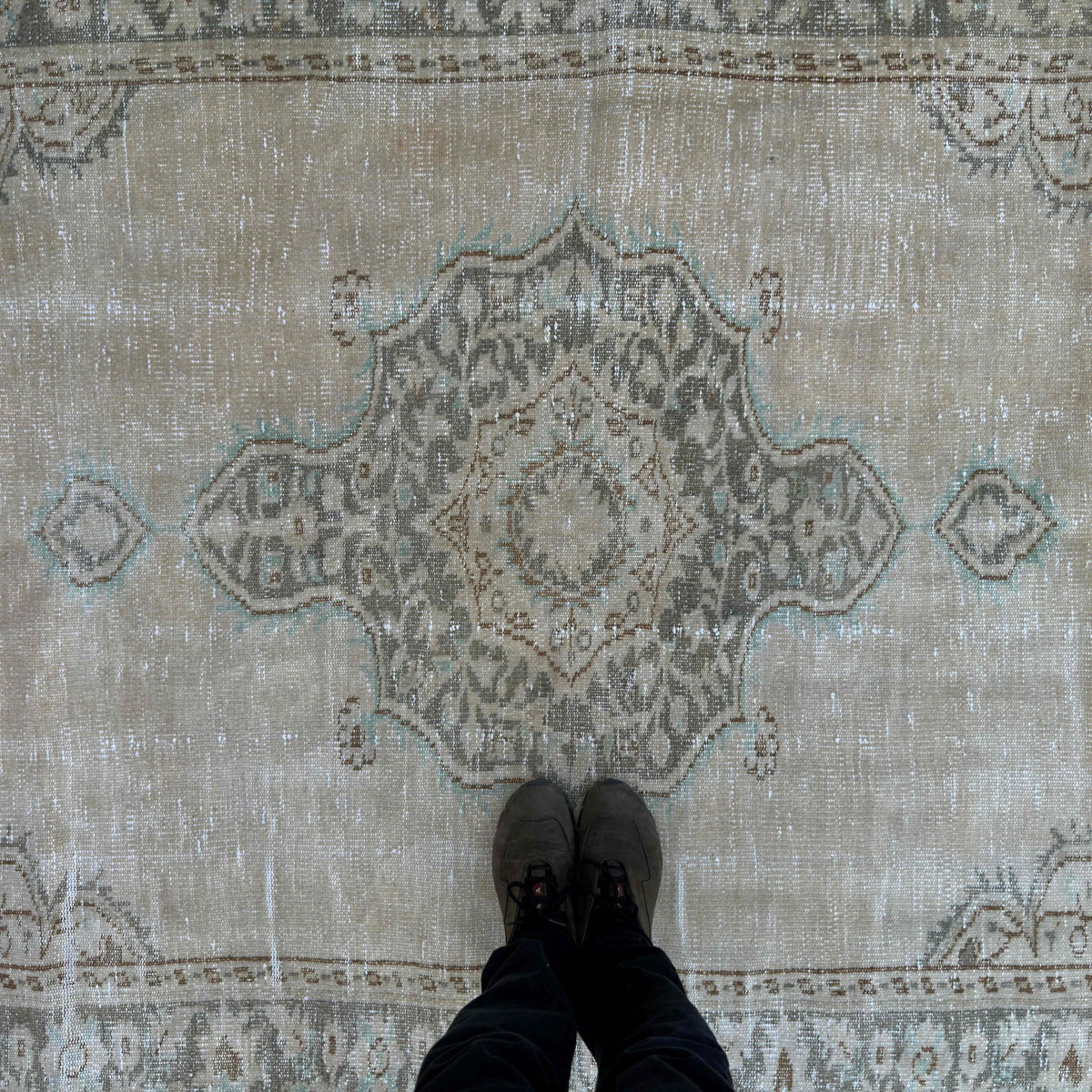 1970s beige vintage Turkish distressed rug with medallion design, hand-knotted weave and low pile.