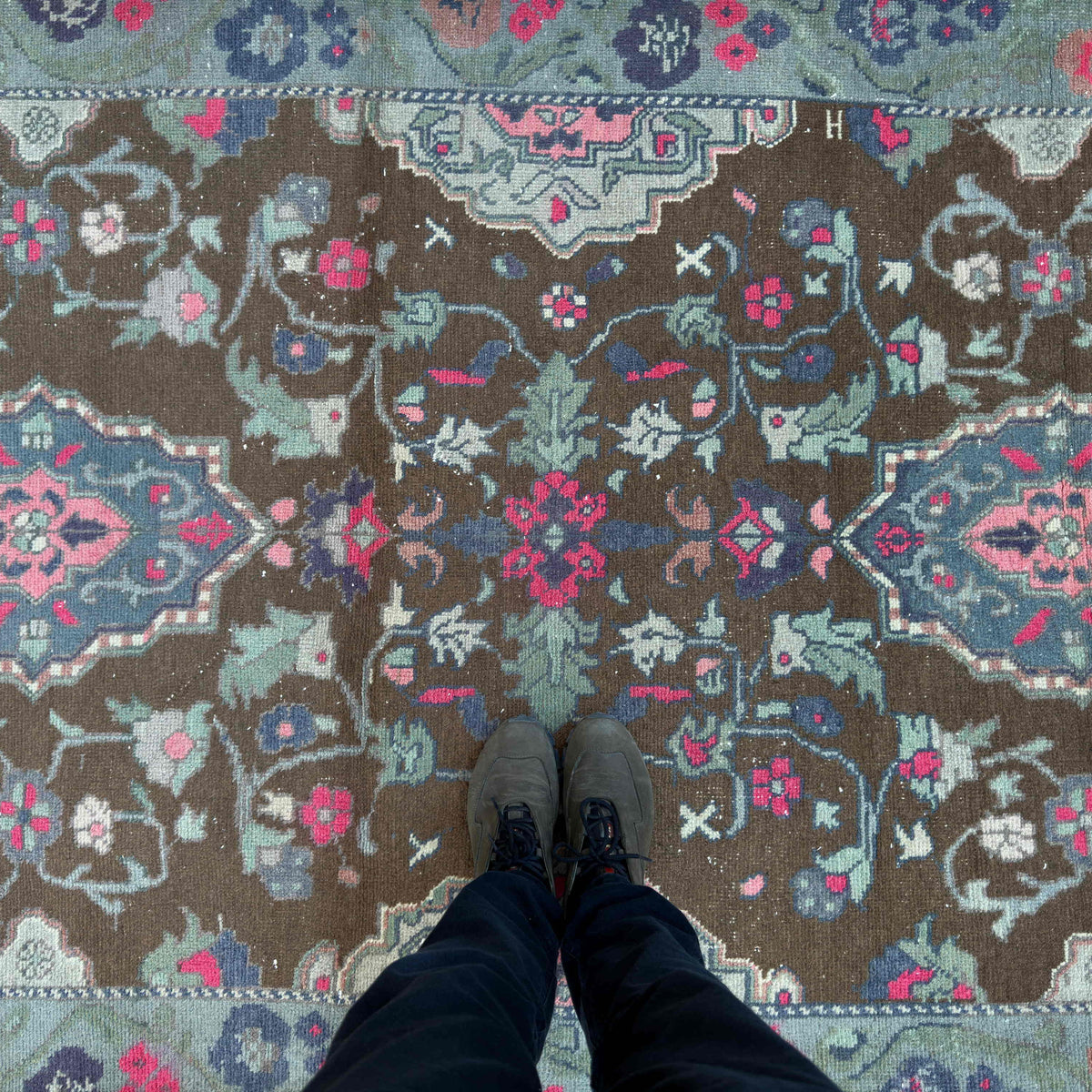 1970s brown vintage Turkish distressed rug with geometric design, hand-knotted weave and low pile.