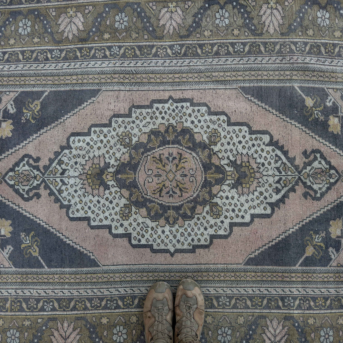 1970s pink vintage Turkish distressed rug with traditional design, hand-knotted weave and low pile.