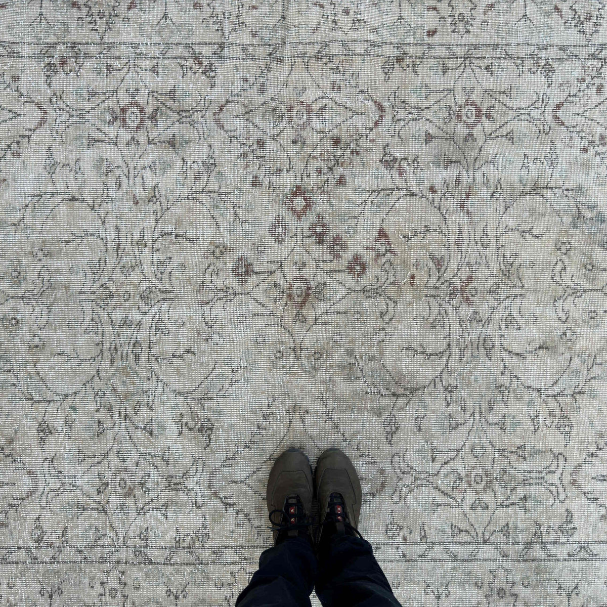 1970s beige vintage Turkish distressed rug with neutral design, hand-knotted weave and low pile.