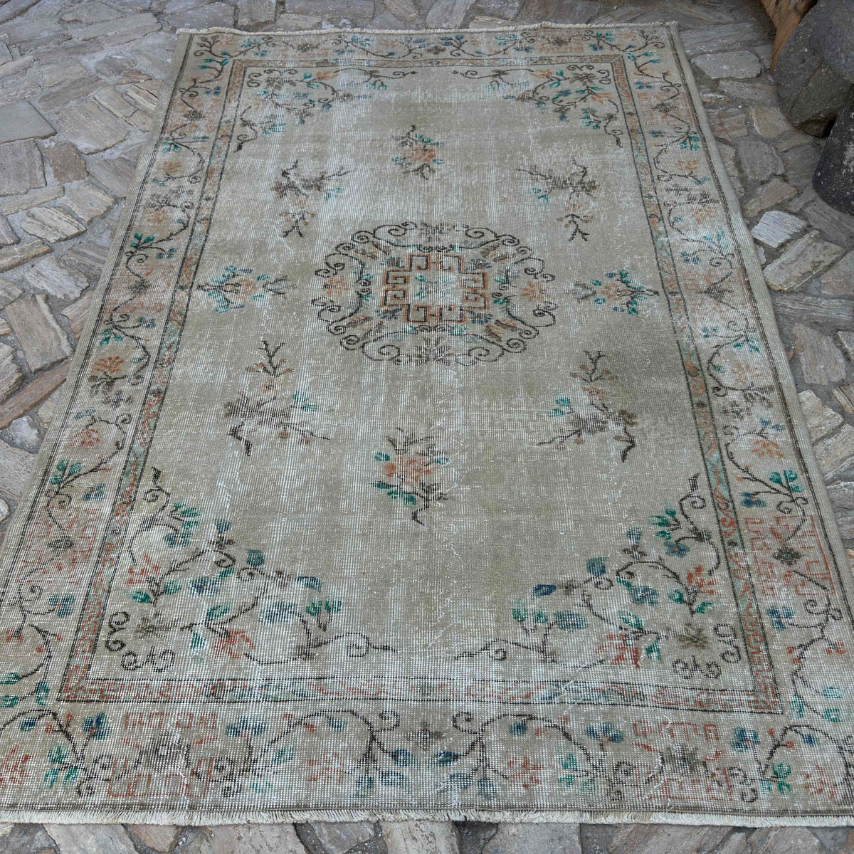 Beige 6' x 8' vintage Turkish distressed rug in wool and cotton, shown on the floor.