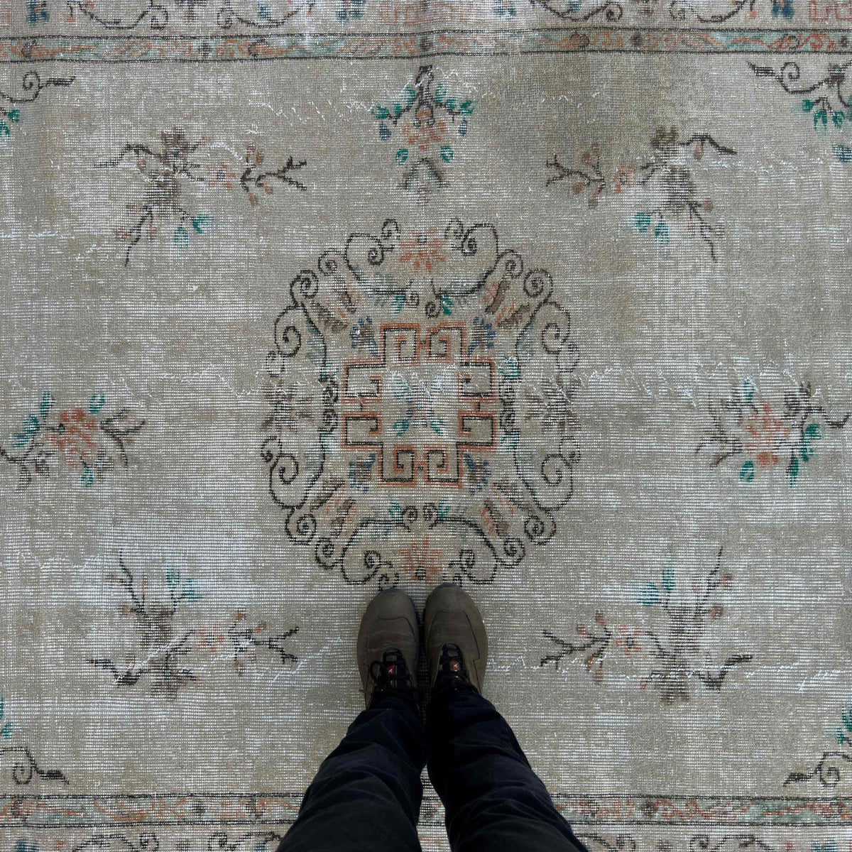 1970s beige vintage Turkish distressed rug with medallion design, hand-knotted weave and low pile.