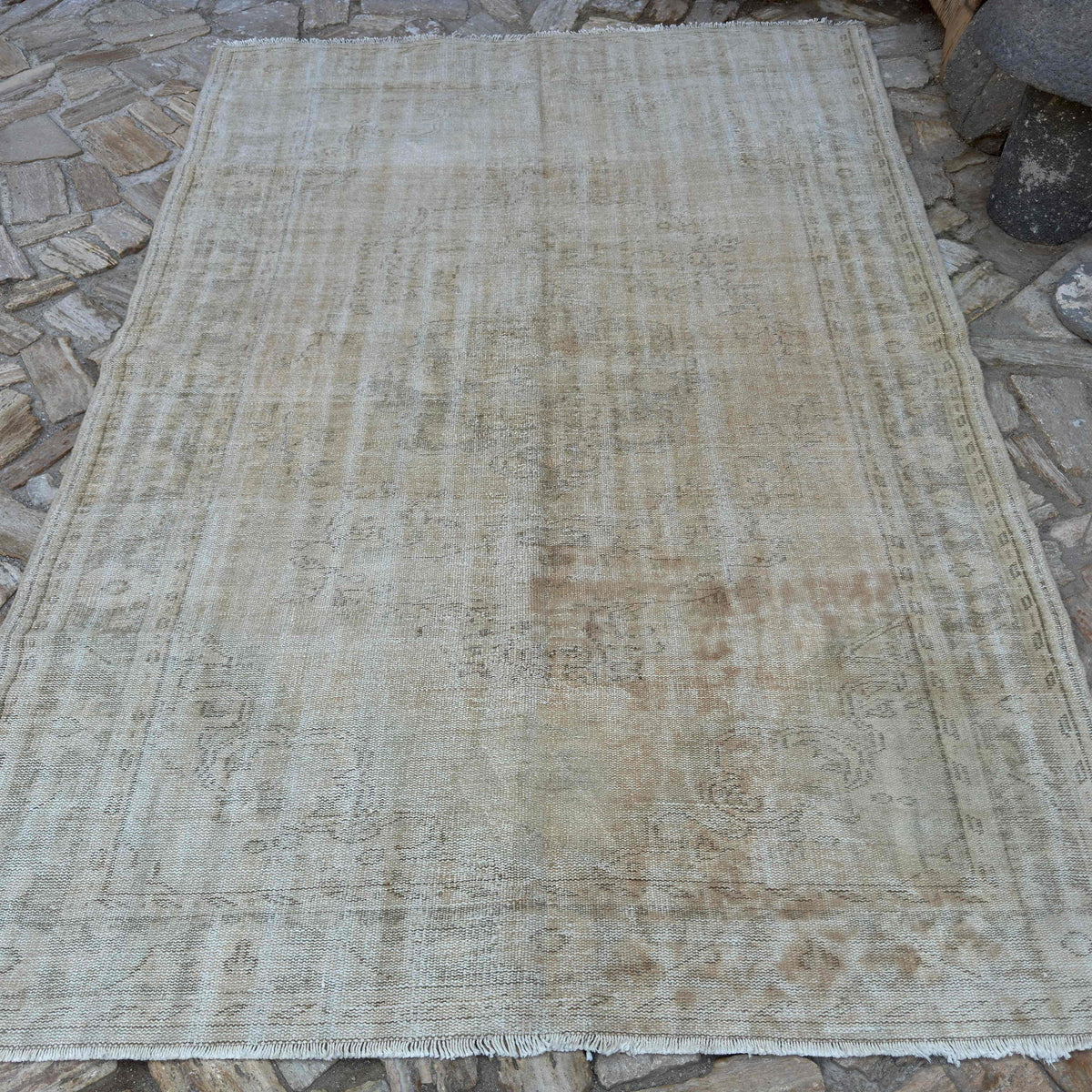 Beige 6' x 9' vintage Turkish distressed rug in wool and cotton, shown on the floor.