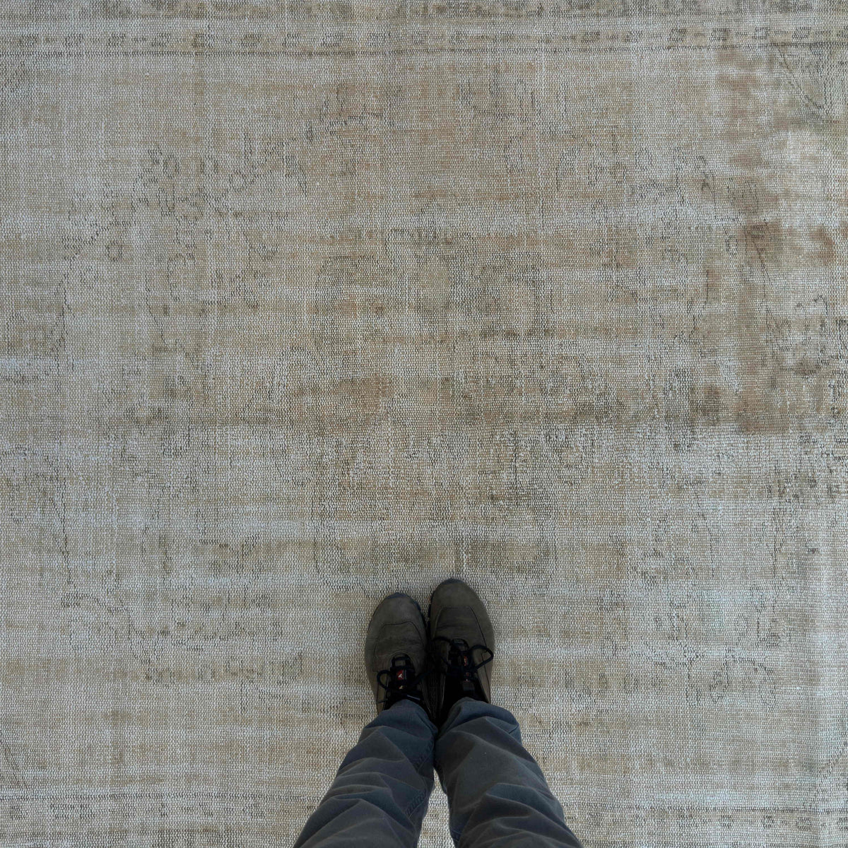 1970s beige vintage Turkish distressed rug with neutral design, hand-knotted weave and low pile.