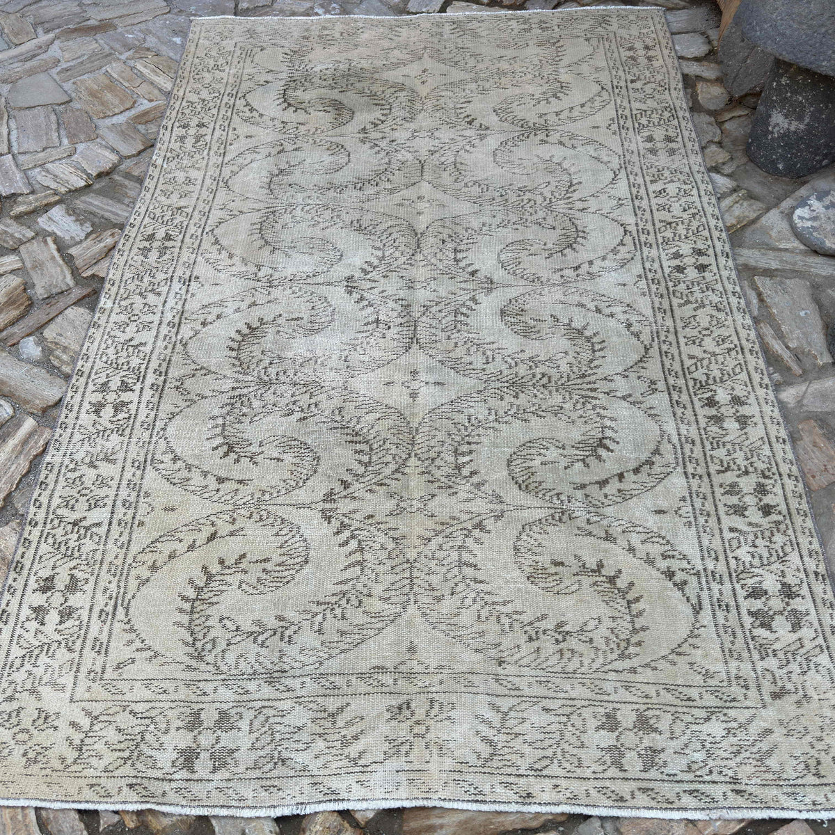 Beige 6' x 9' vintage Turkish distressed rug in wool and cotton, shown on the floor.