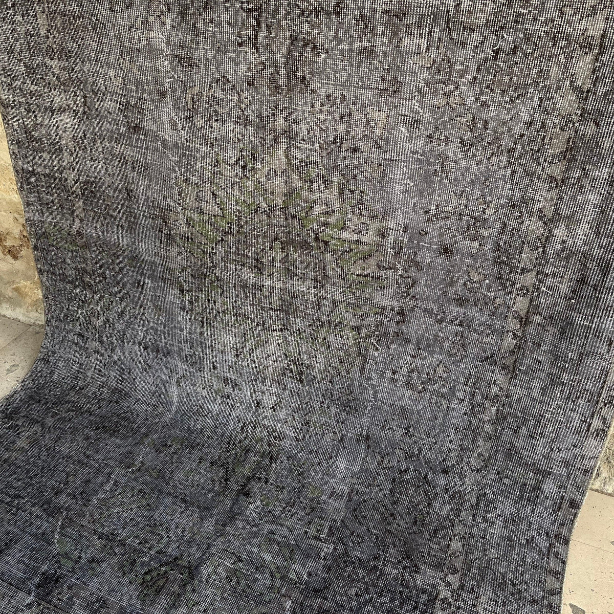 Black 6' x 9' vintage Turkish distressed rug in wool and cotton, shown on the floor.