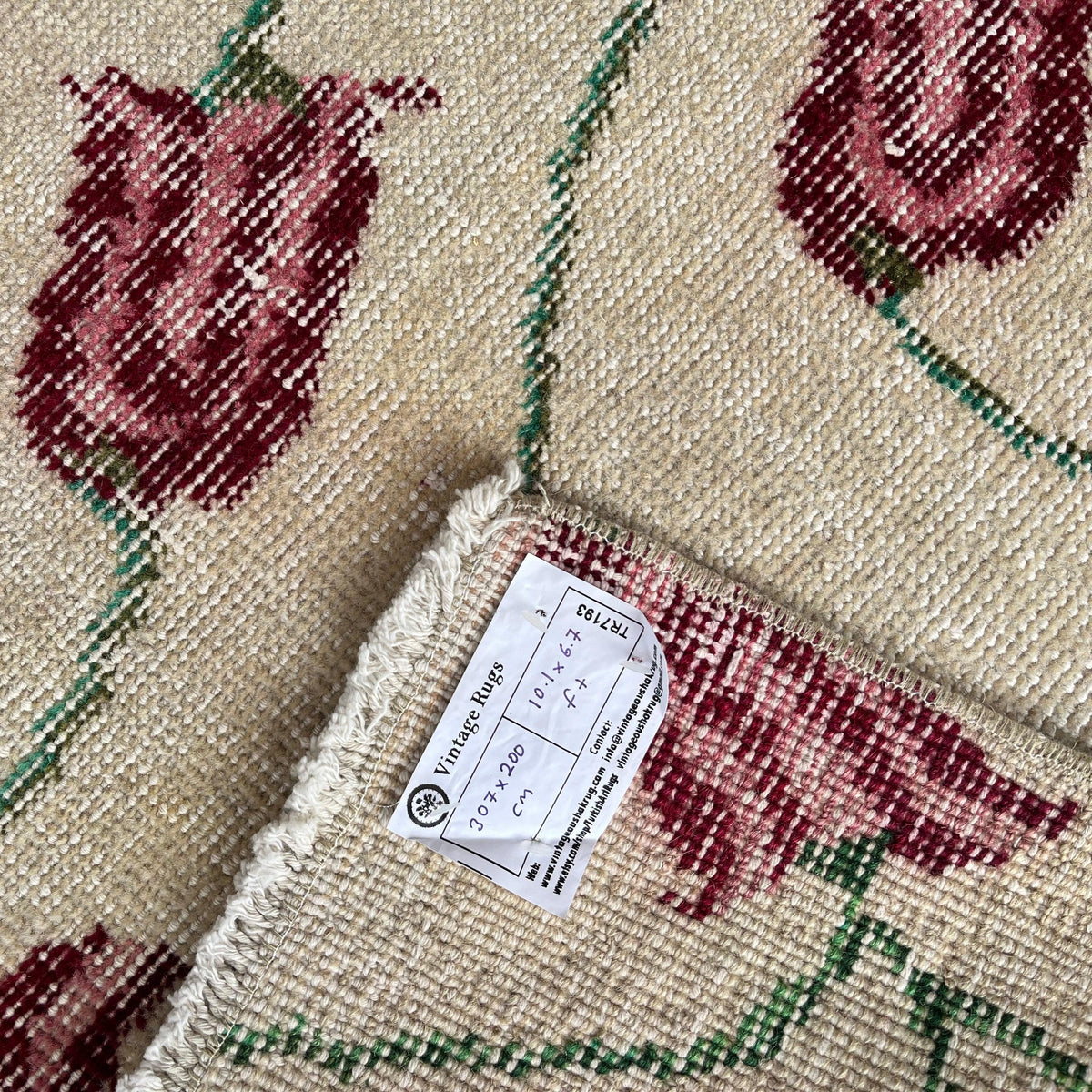 1970s beige vintage Turkish distressed rug with floral design, hand-knotted weave and low pile.