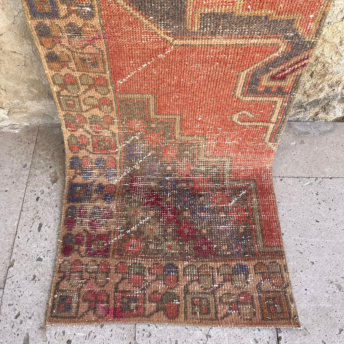 Red 2' x 8' vintage Turkish distressed runner rug in wool and cotton, shown on the floor.