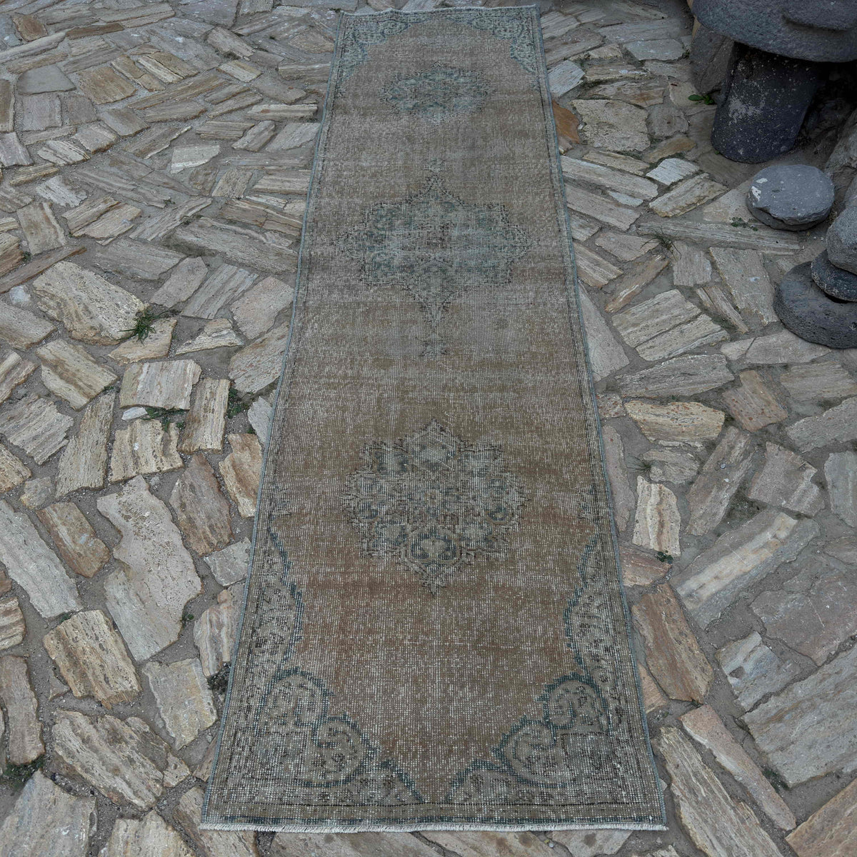 Beige 3' x 10' vintage Turkish distressed runner rug in wool and cotton, shown on the floor.