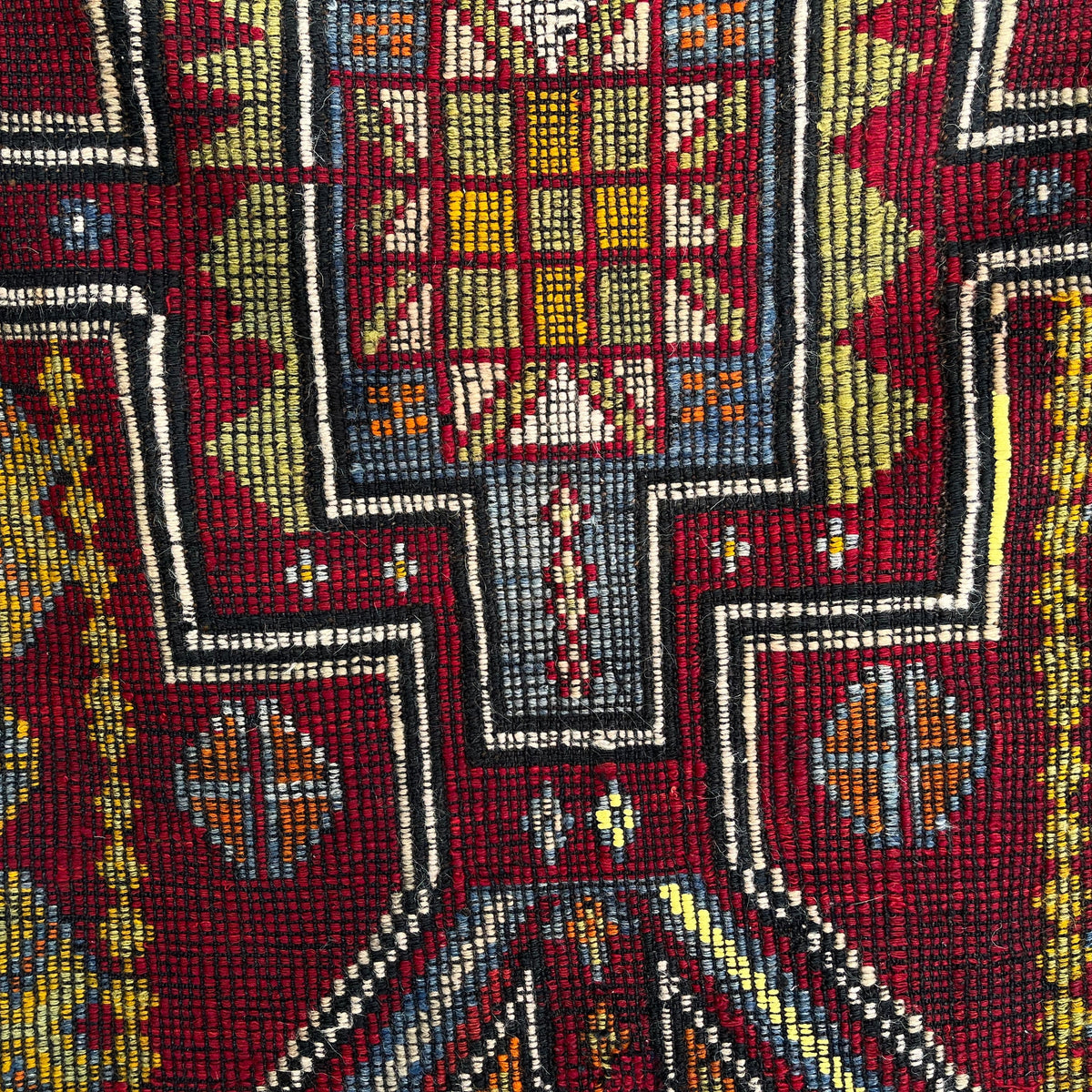 Close-up of the red vintage Turkish flatweave rug showing traditional details, flatweave construction, wool and cotton and low pile.
