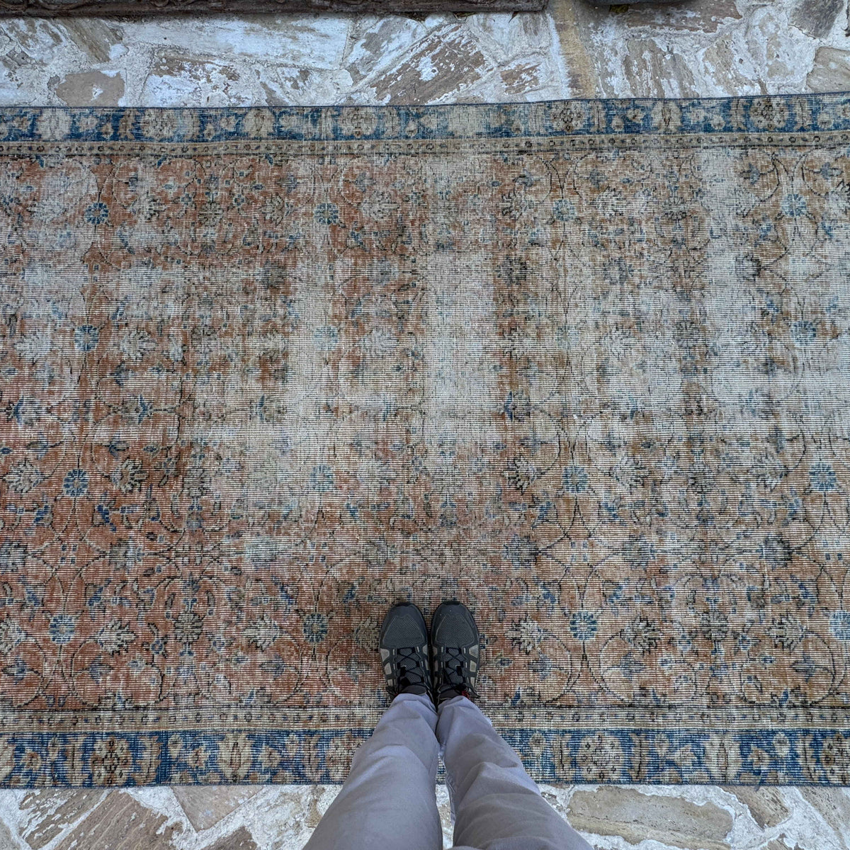 1970s orange vintage Turkish floral rug with floral design, hand-knotted weave and low pile.