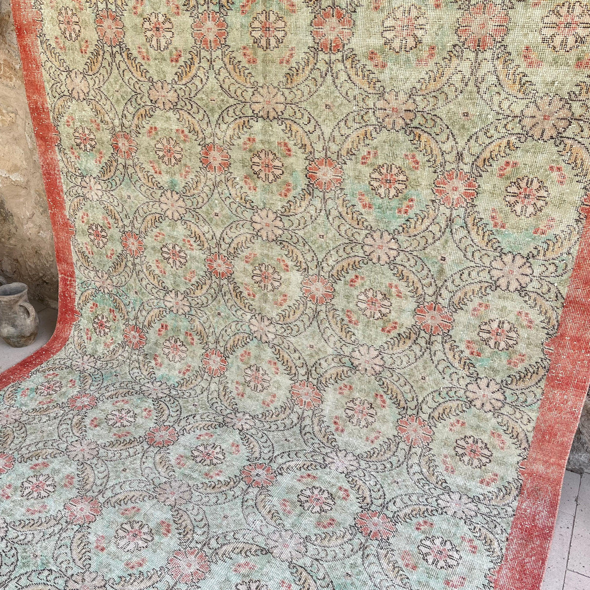 Pale Green 7' x 11' vintage Turkish floral rug in wool and cotton, shown on the floor.
