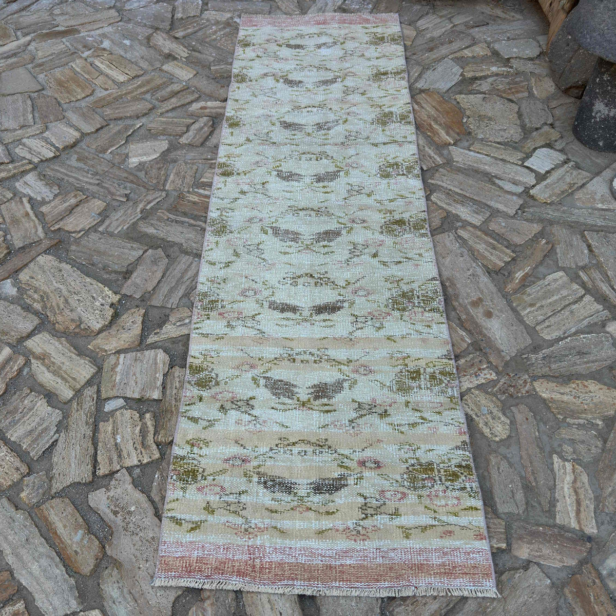 Beige 3' x 9' vintage Turkish floral runner rug in wool and cotton, shown on the floor.