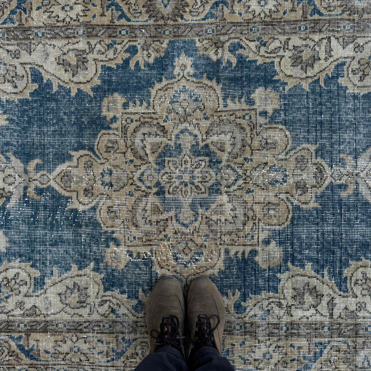 1970s blue vintage Turkish geometric rug with medallion design, hand-knotted weave and low pile.
