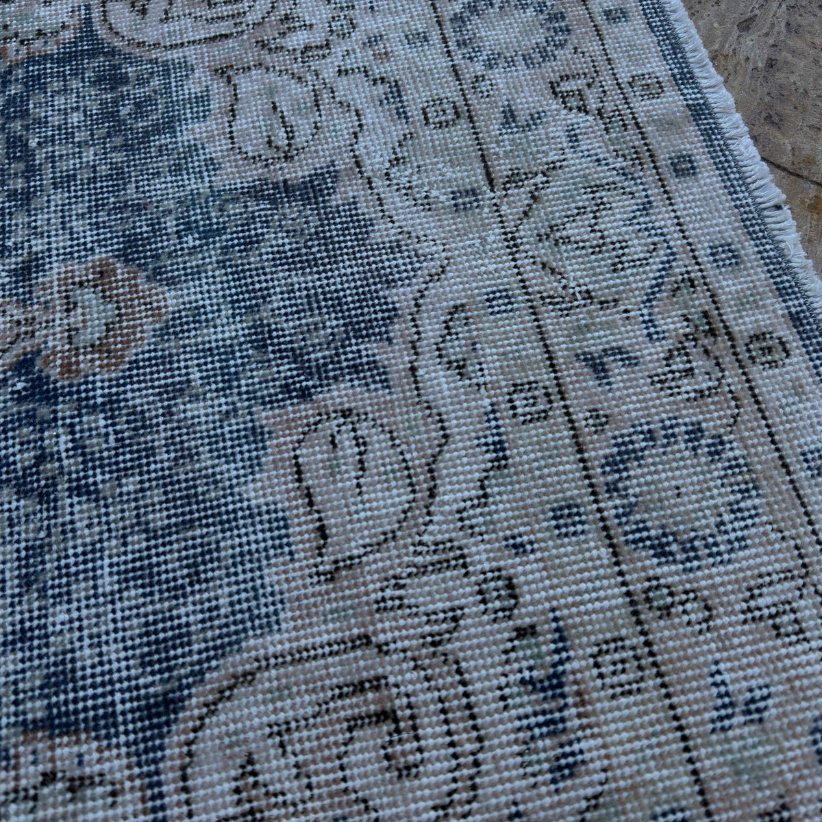 Close-up of the blue vintage Turkish geometric rug showing medallion details, hand-knotted weave, wool and cotton and low pile.