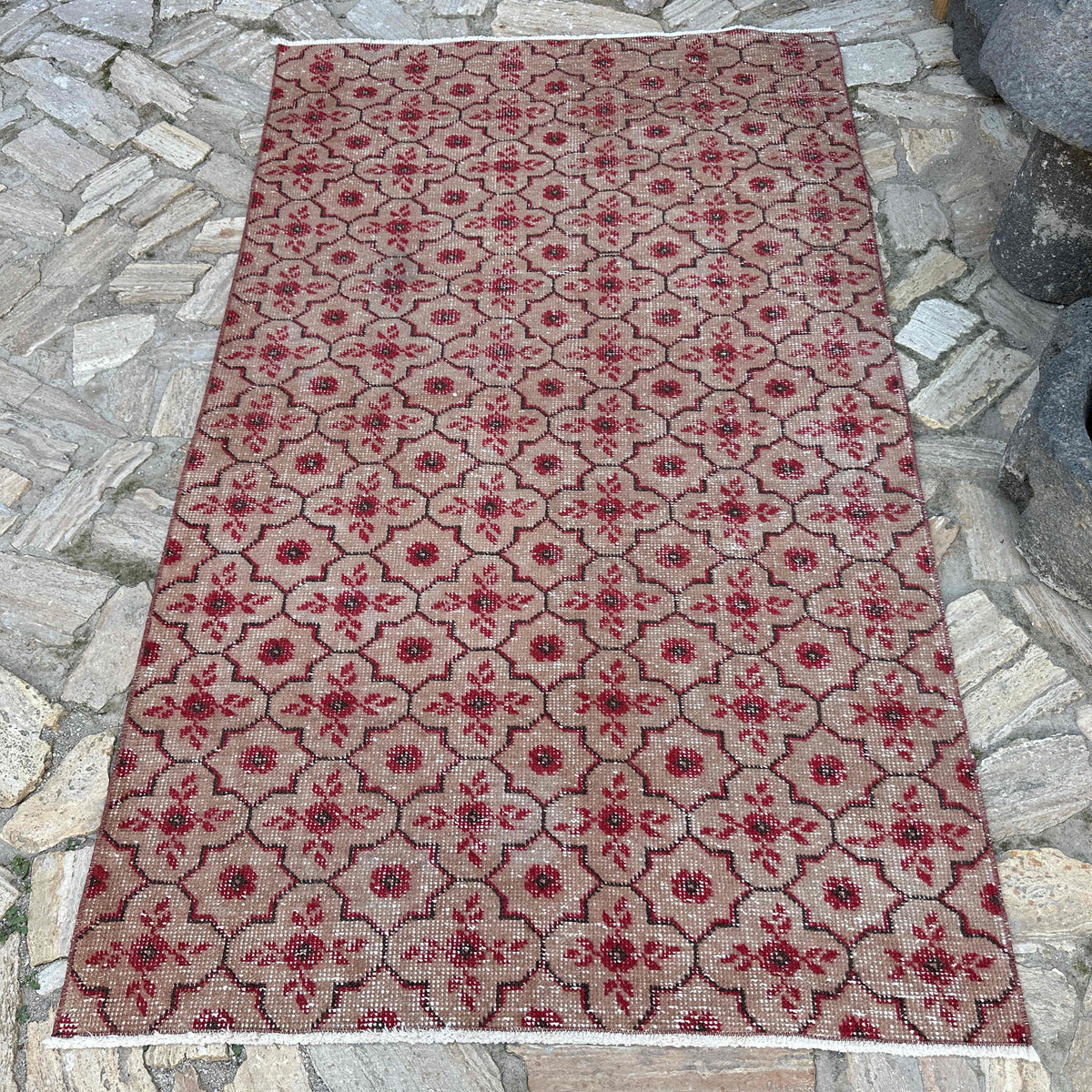 Red 4' x 7' vintage Turkish geometric rug in wool and cotton, shown on the floor.