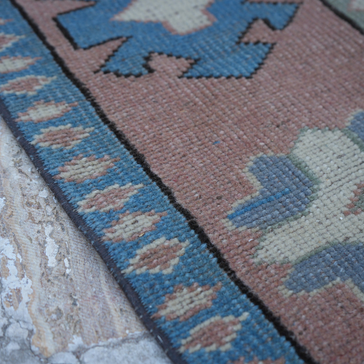 Beige 6' x 7' vintage Turkish geometric rug in wool, shown on the floor.