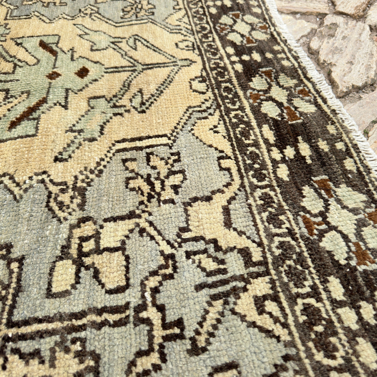Close-up of the brown vintage Turkish geometric rug showing medallion details, hand-knotted weave, wool and cotton and low pile.