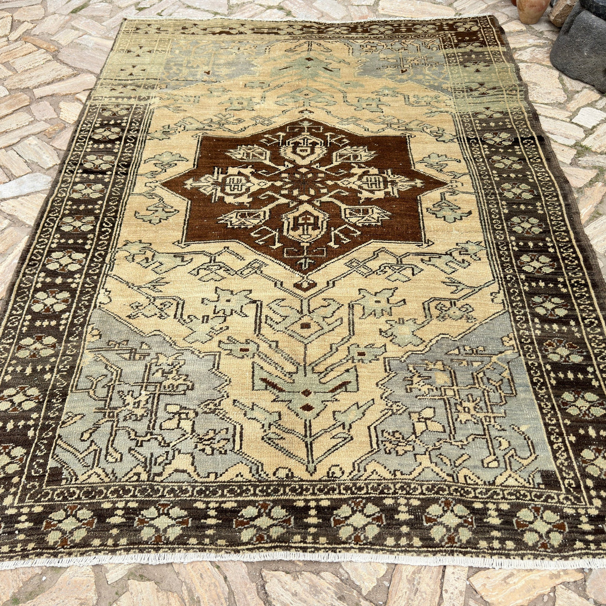 Brown 7' x 9' vintage Turkish geometric rug in wool and cotton, shown on the floor.