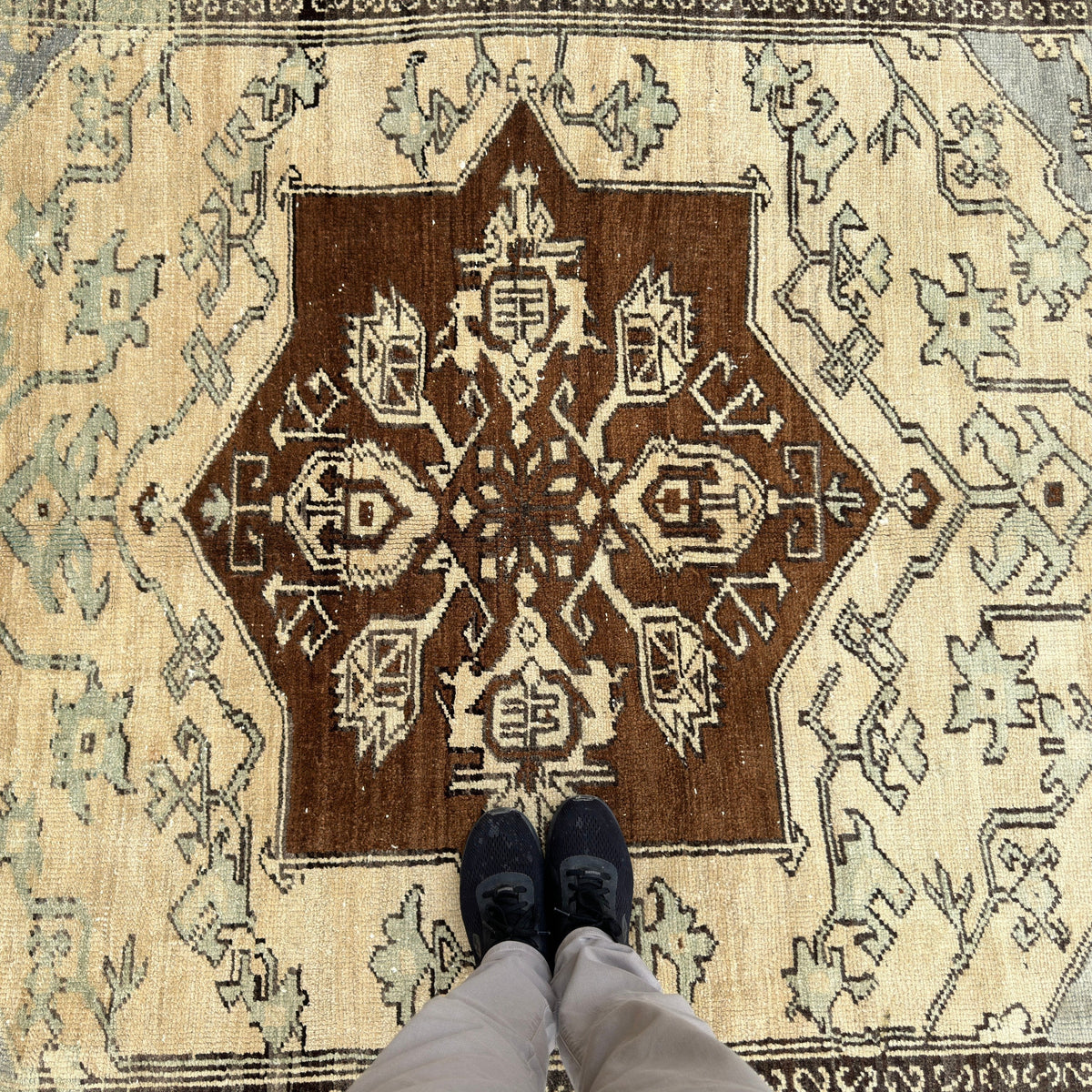 1970s brown vintage Turkish geometric rug with medallion design, hand-knotted weave and low pile.