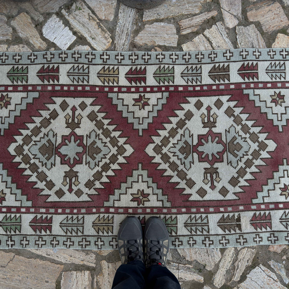 1970s red vintage Turkish geometric runner rug with neutral design, hand-knotted weave and low pile.