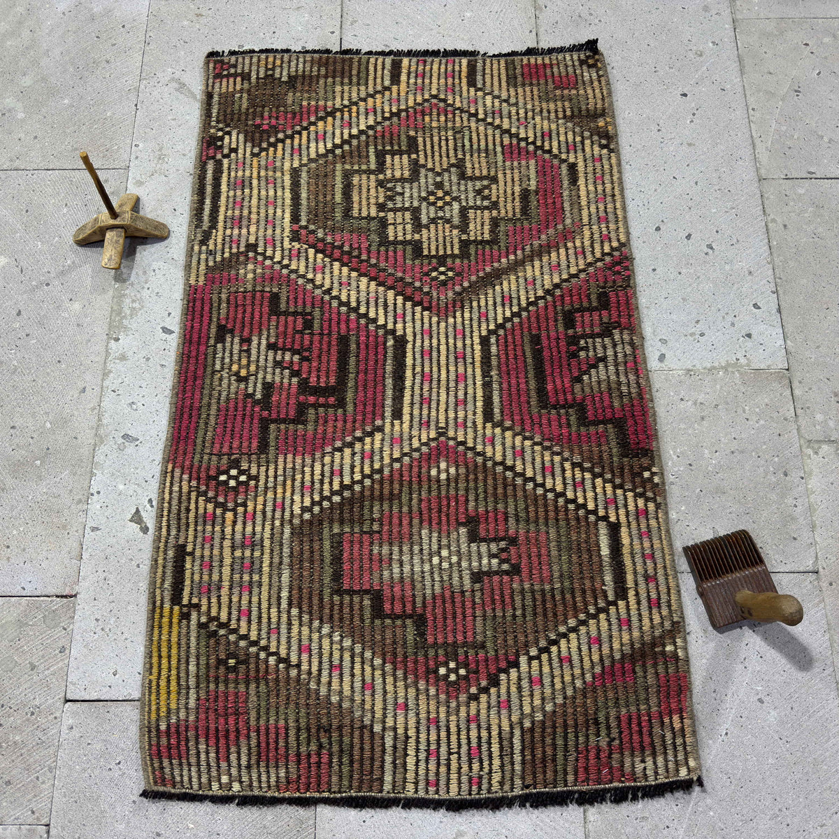 Pink 2' x 3' vintage Turkish kilim rug in wool and cotton, shown on the floor.