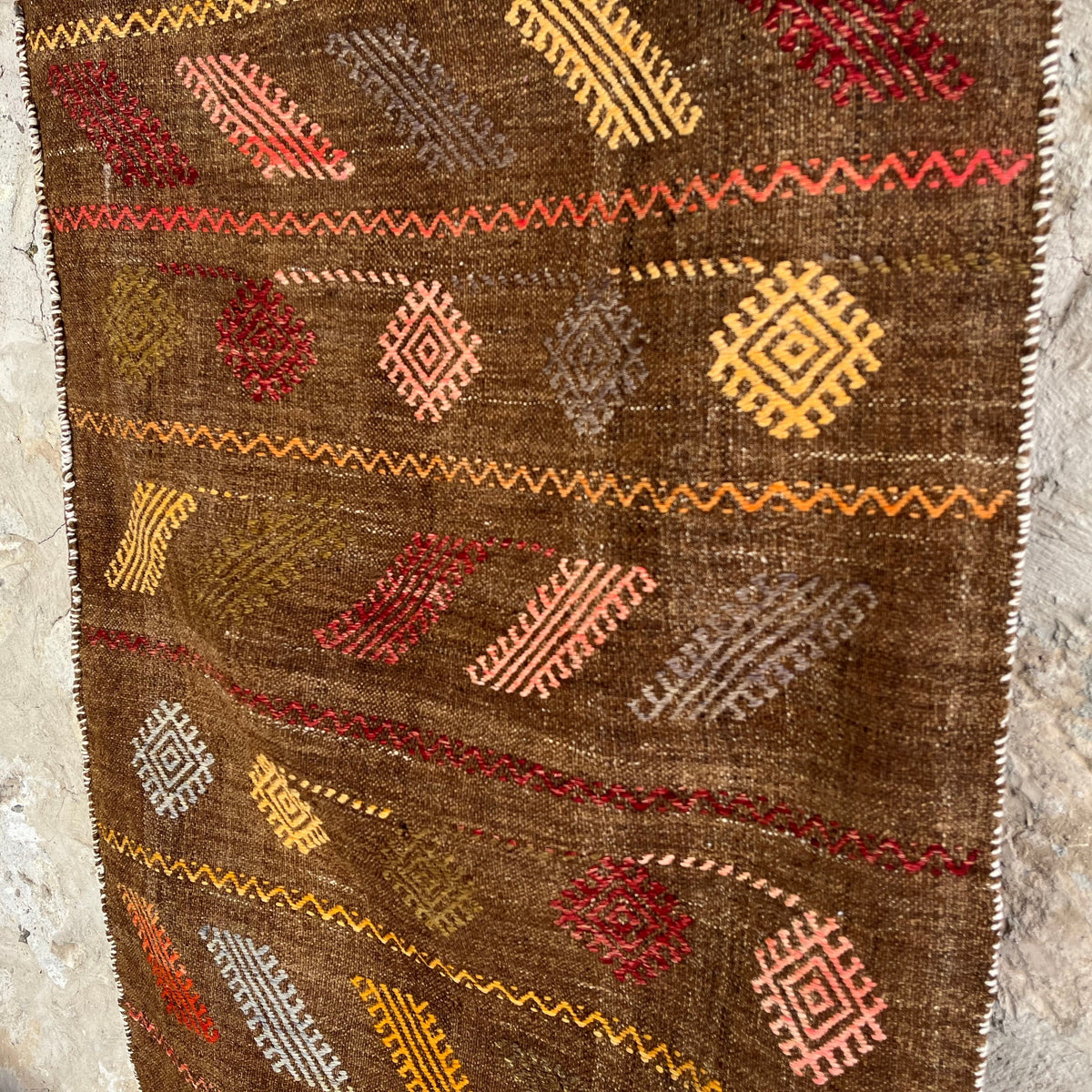 1970s brown vintage Turkish kilim rug with traditional design, flatweave construction and low pile.