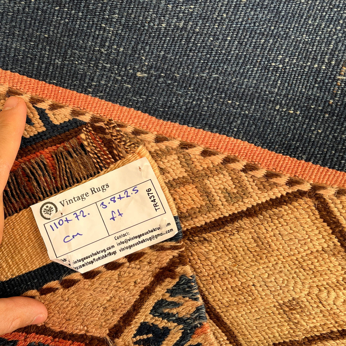 Close-up of the pink vintage Turkish kilim rug showing traditional details, flatweave construction, wool and cotton and low pile.