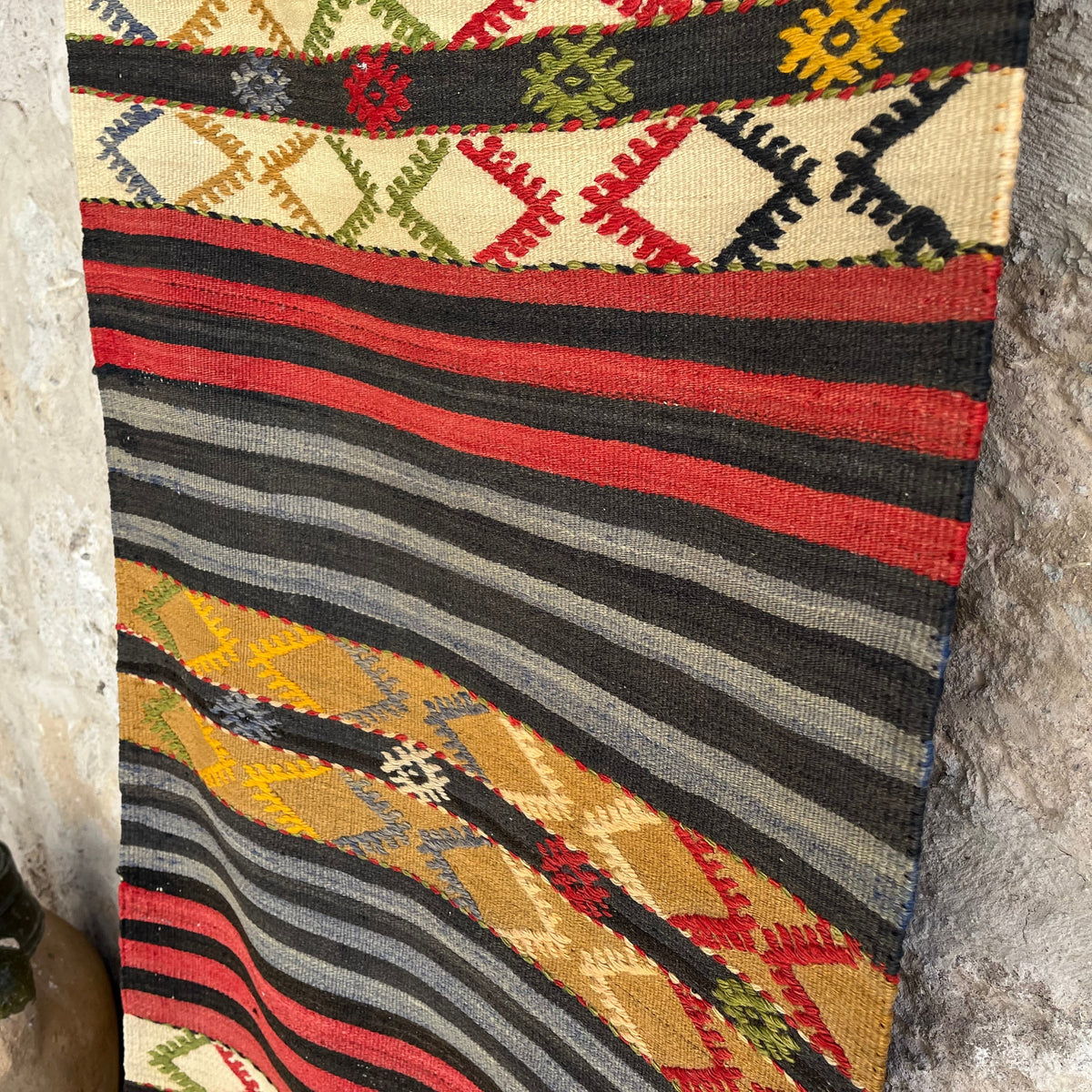 Close-up of the blue vintage Turkish kilim rug showing striped details, flatweave construction, wool and cotton and low pile.