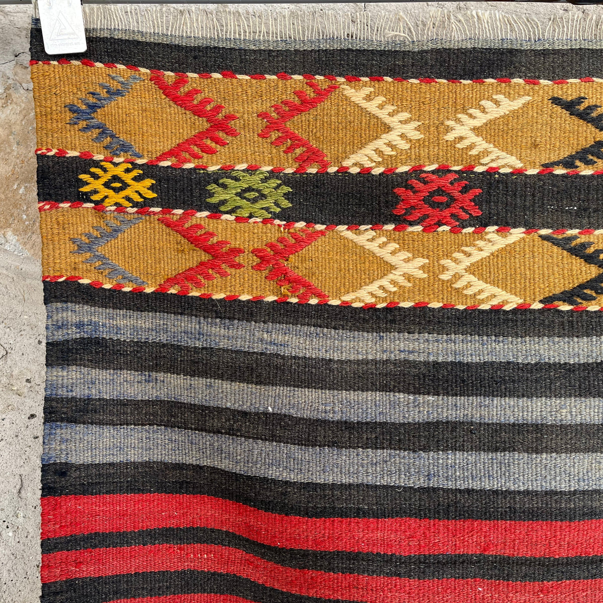 Blue 2' x7' vintage Turkish kilim rug in wool and cotton, shown on the floor.