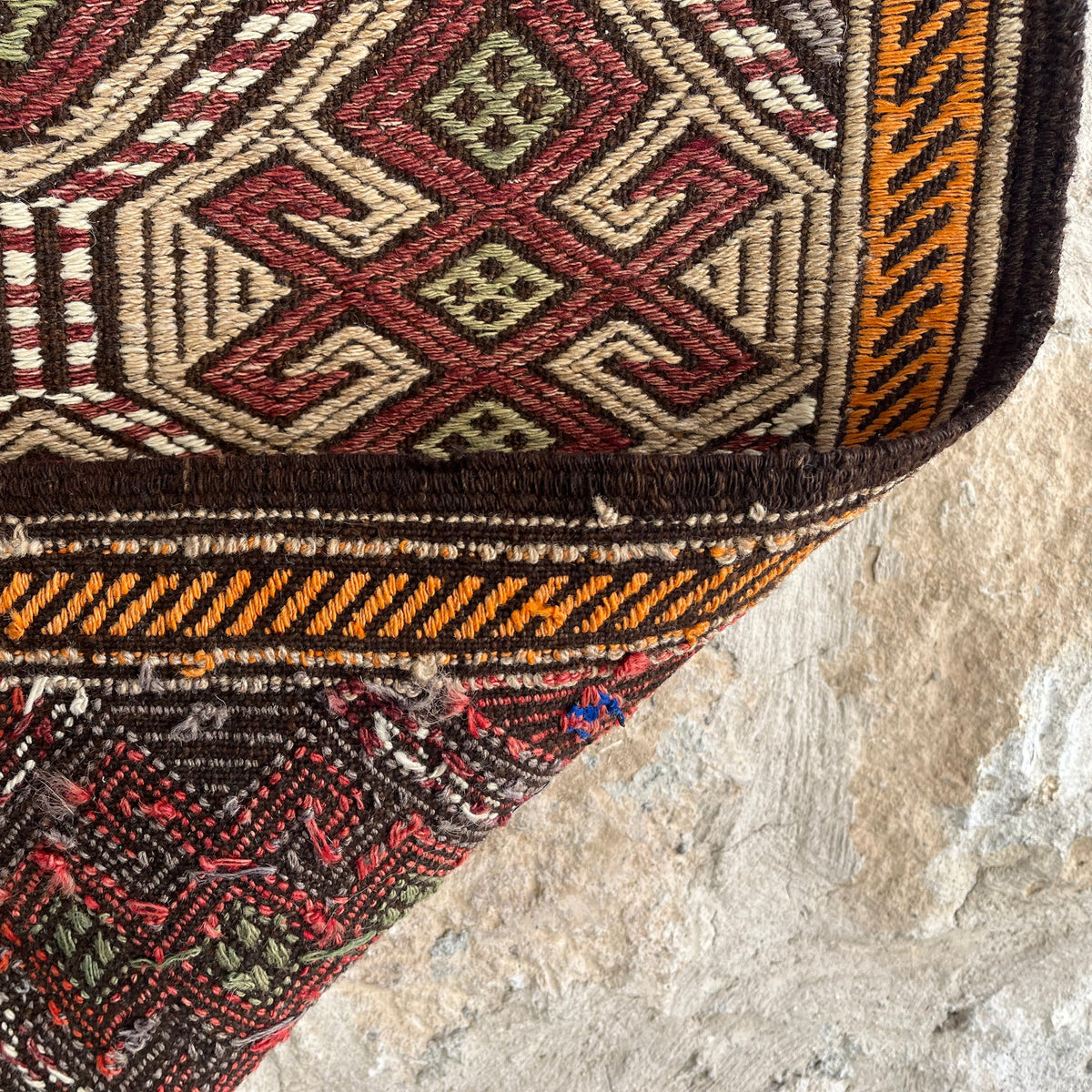 Close-up of the brown vintage Turkish kilim rug showing traditional details, flatweave construction, wool and cotton and low pile.
