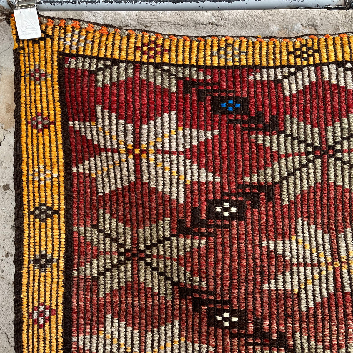 1970s red vintage Turkish kilim rug with traditional design, flatweave construction and low pile.