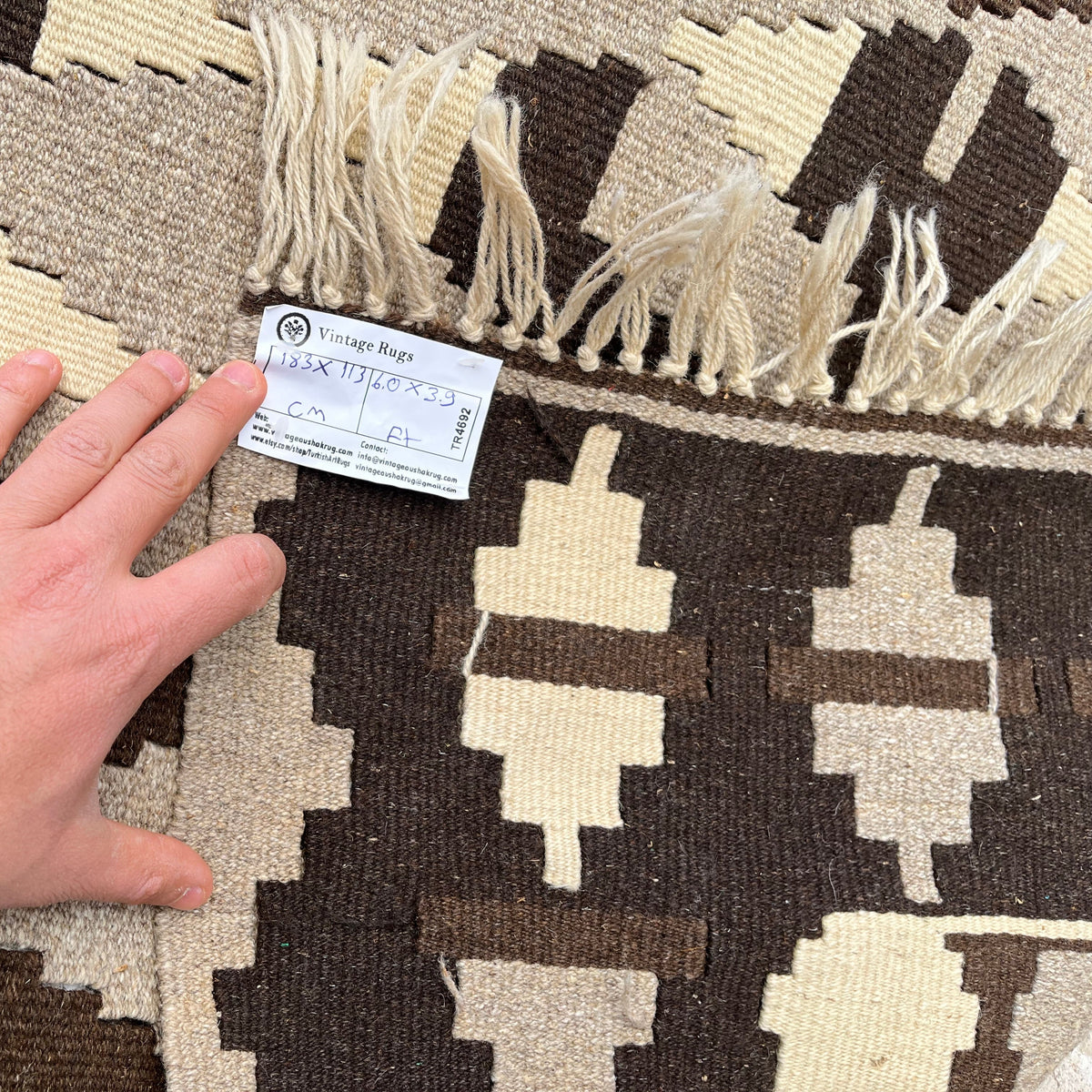 Close-up of the black vintage Turkish kilim rug showing traditional details, flatweave construction, wool and cotton and low pile.