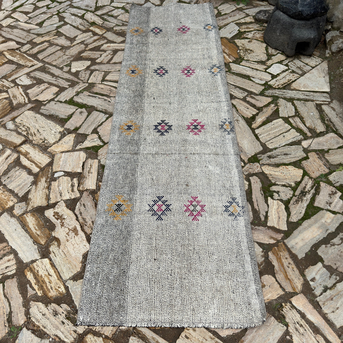 Gray 3' x 10' vintage Turkish kilim runner rug in wool and cotton, shown on the floor.