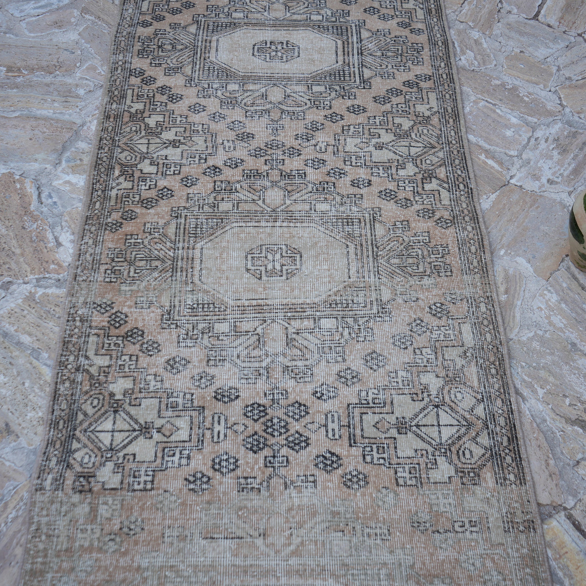 Close-up of the beige vintage Turkish long runner rug showing traditional details, hand-knotted weave, wool and cotton and low pile.