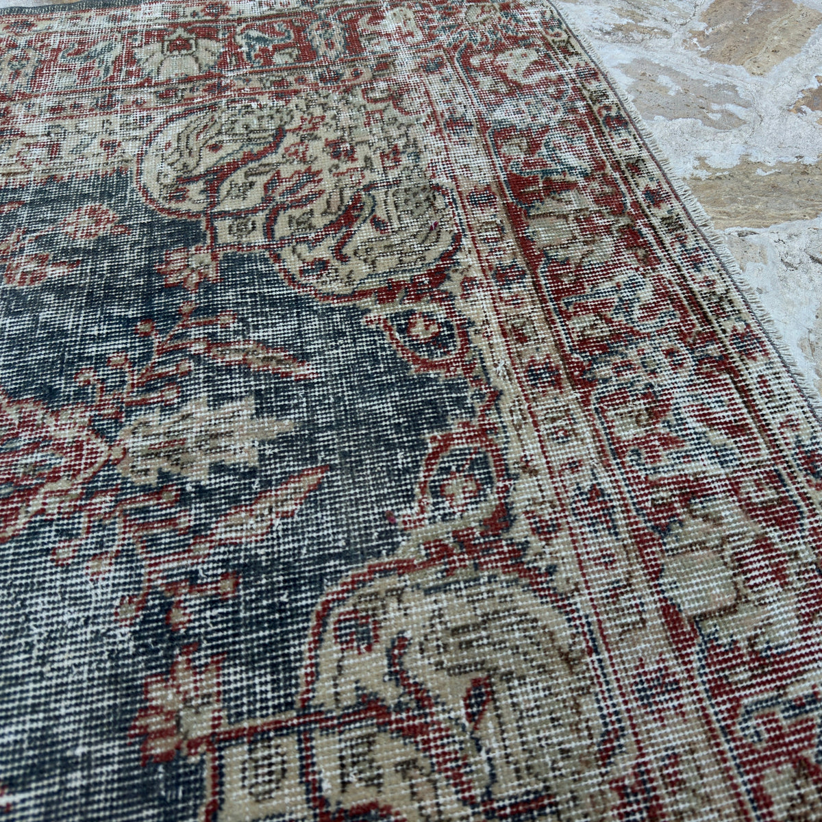 Close-up of the blue vintage Turkish medallion rug showing traditional details, hand-knotted weave, wool and cotton and low pile.