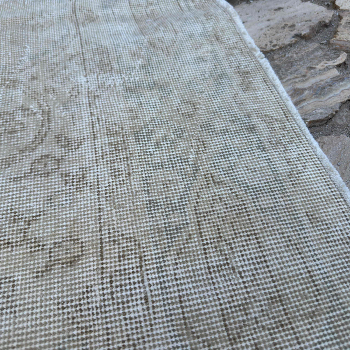 Close-up of the beige vintage Turkish medallion rug showing neutral details, hand-knotted weave, wool and cotton and low pile.