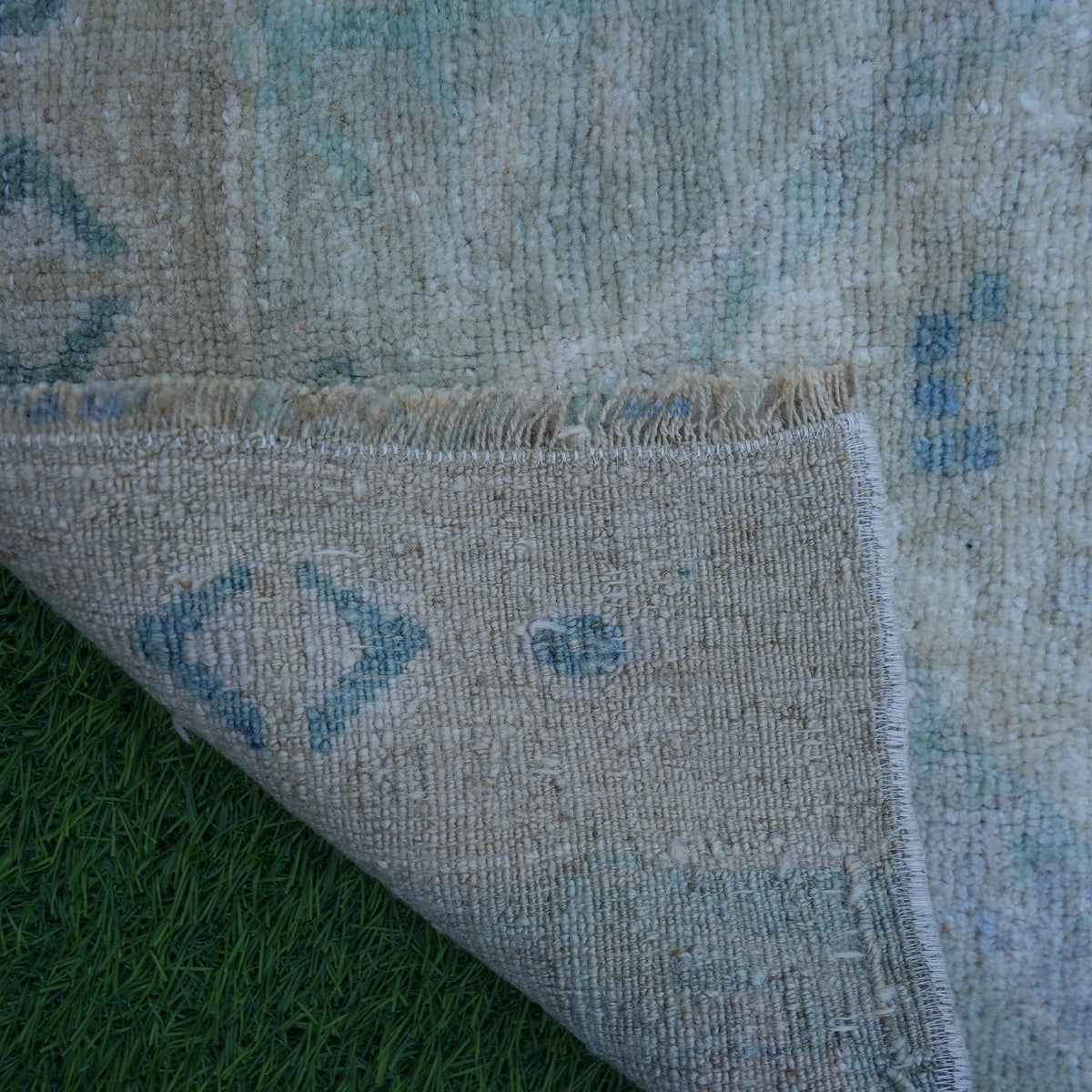 1970s beige vintage Turkish mini rug with traditional design, hand-knotted weave and low pile.