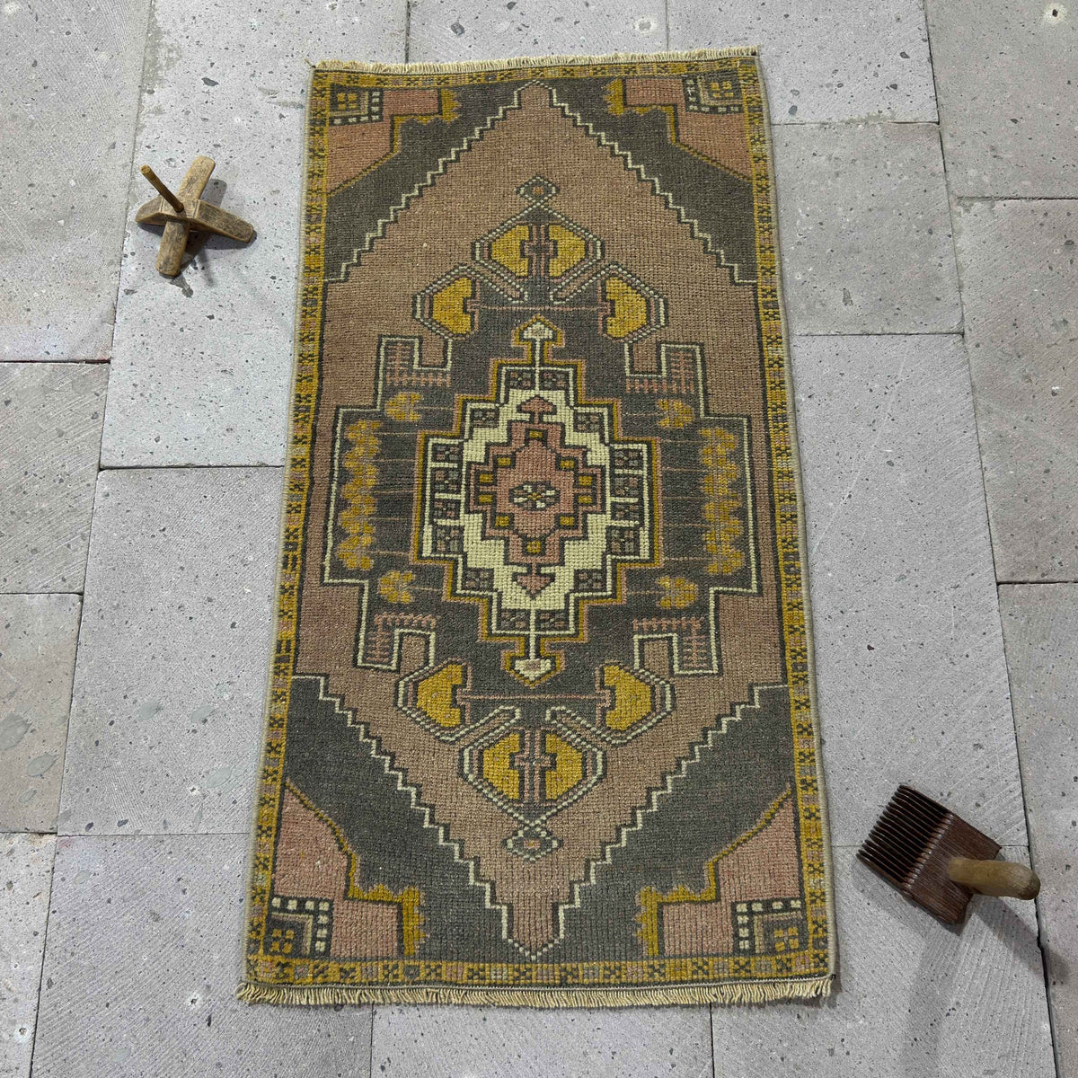 Yellow 2' x 3' vintage Turkish mini rug in wool and cotton, shown on the floor.