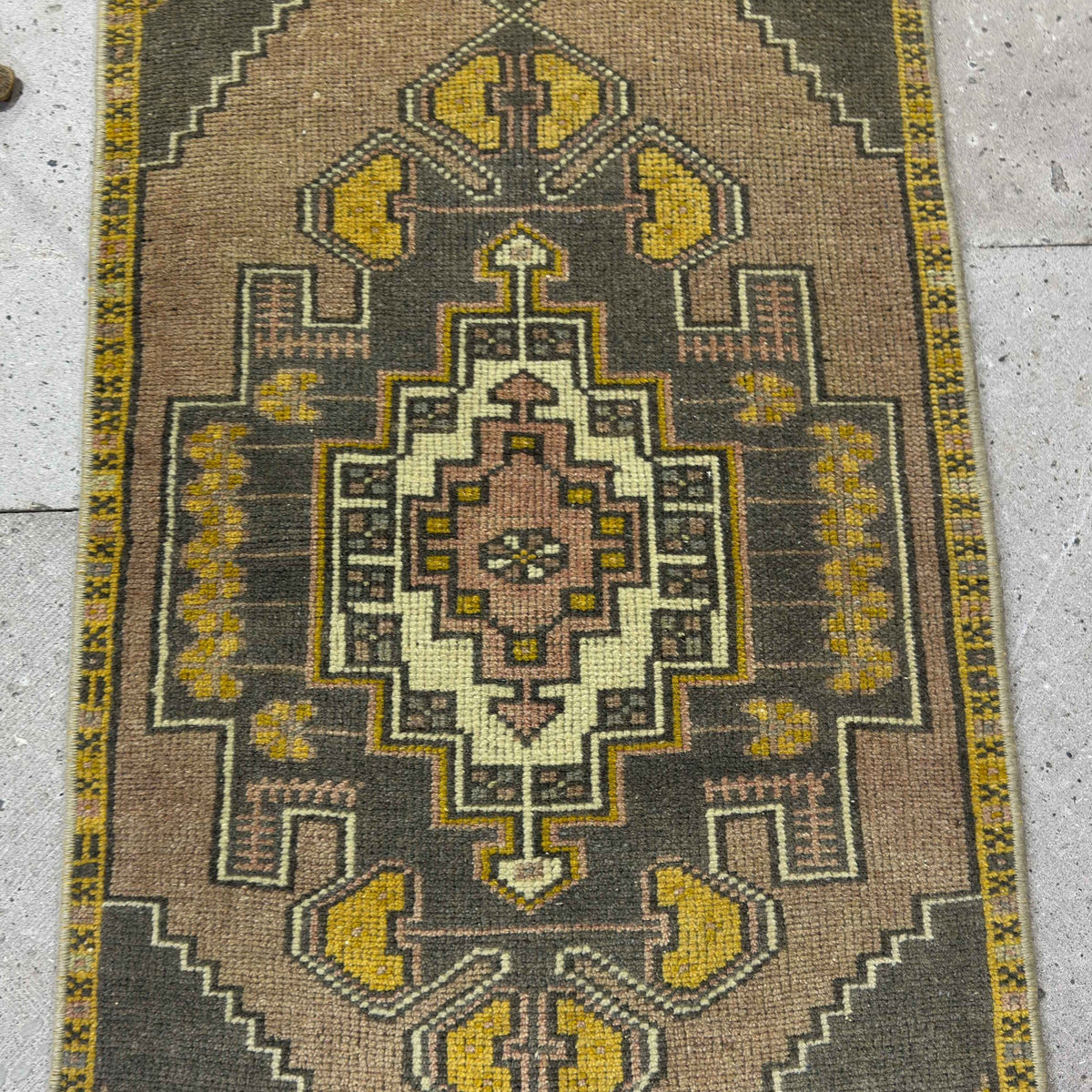 1970s yellow vintage Turkish mini rug with traditional design, hand-knotted weave and low pile.
