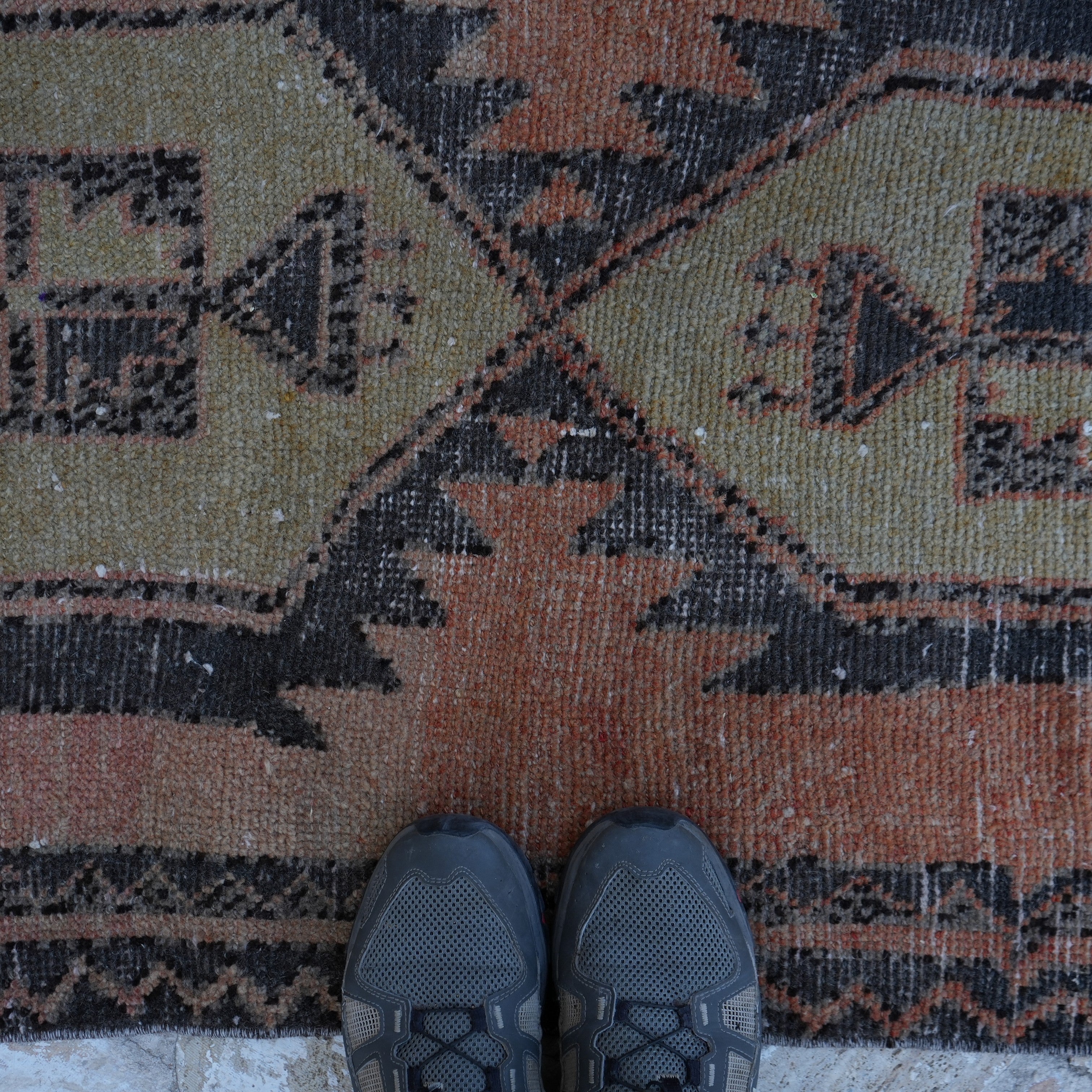 Orange 2' x 6' vintage Turkish mini runner in wool and cotton, shown on the floor.