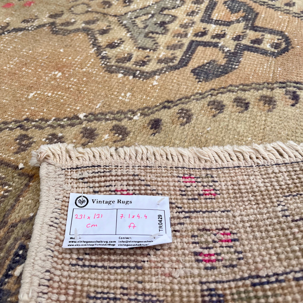 Close-up of the blue vintage Turkish oriental rug showing traditional details, hand-knotted weave, wool and cotton and low pile.
