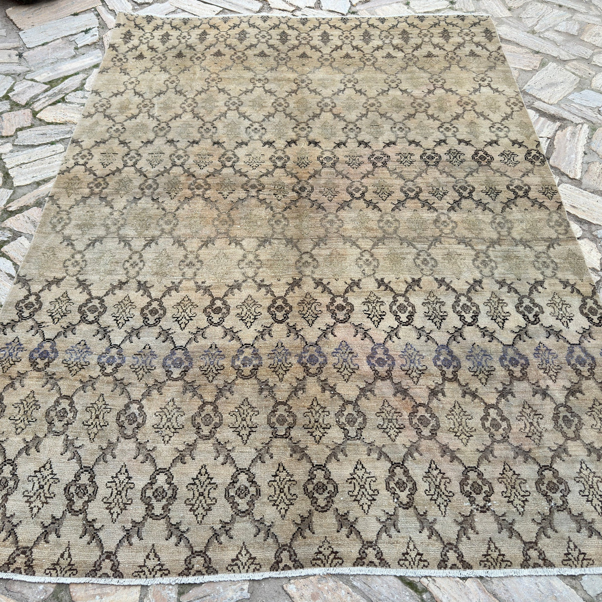 Beige 6' x 9' vintage Turkish oushak rug in wool and cotton, shown on the floor.