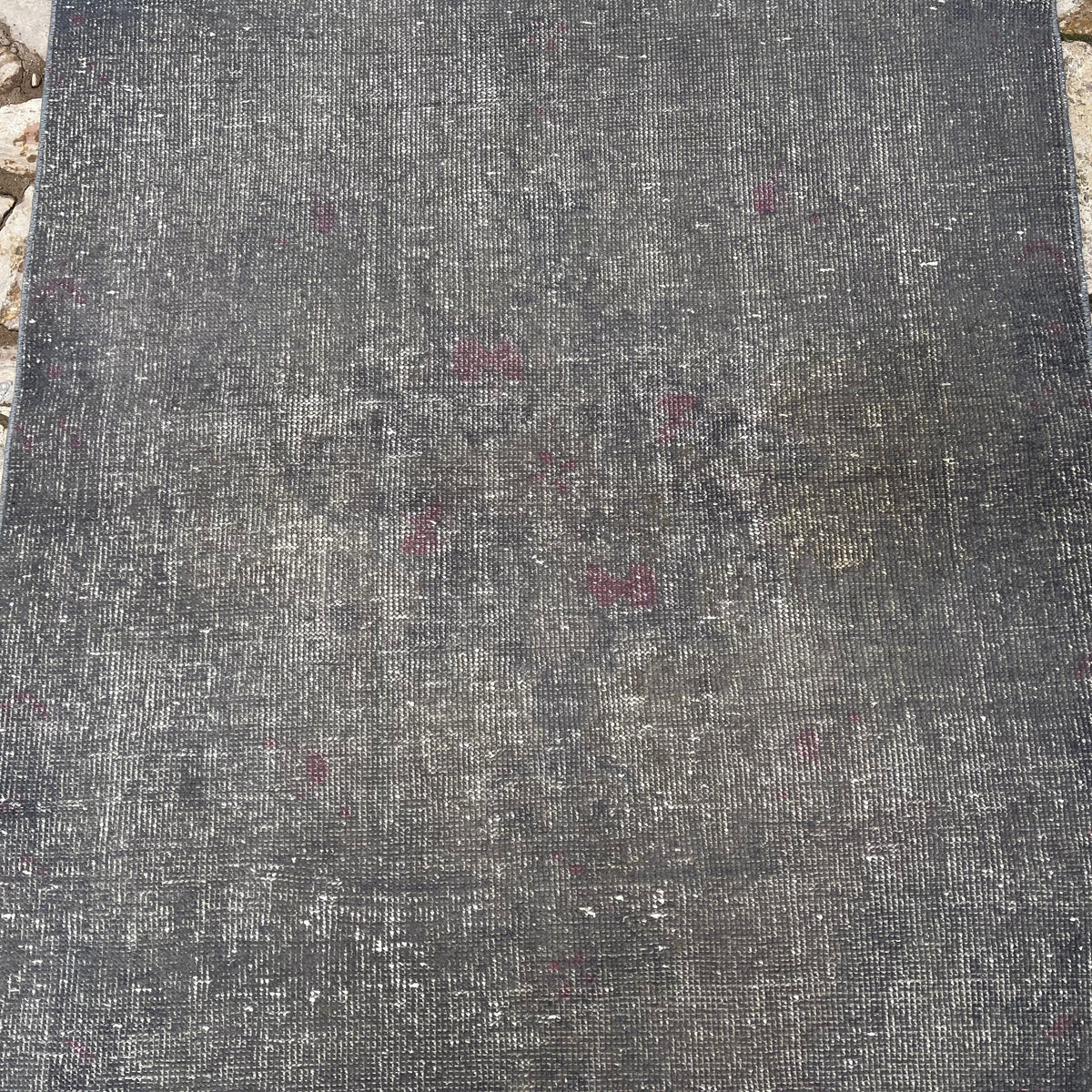 1970s gray vintage Turkish overdyed rug with overdyed design, hand-knotted weave and low pile.